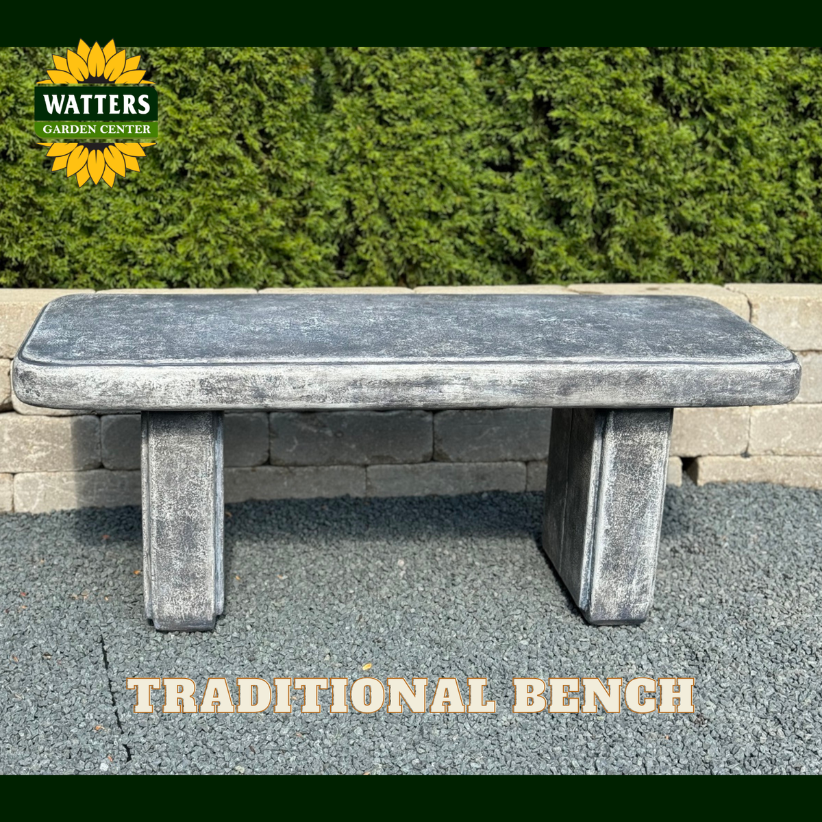 A rectangular stone bench with a weathered gray finish, set outdoors on a paved surface in front of a green hedge. The Watters Garden Center logo is visible in the top-left corner, and the text 'TRADITIONAL BENCH' is displayed at the bottom.