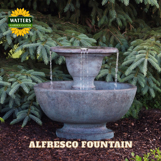 Two-tiered stone fountain with Watters Garden Center branding in a garden setting.