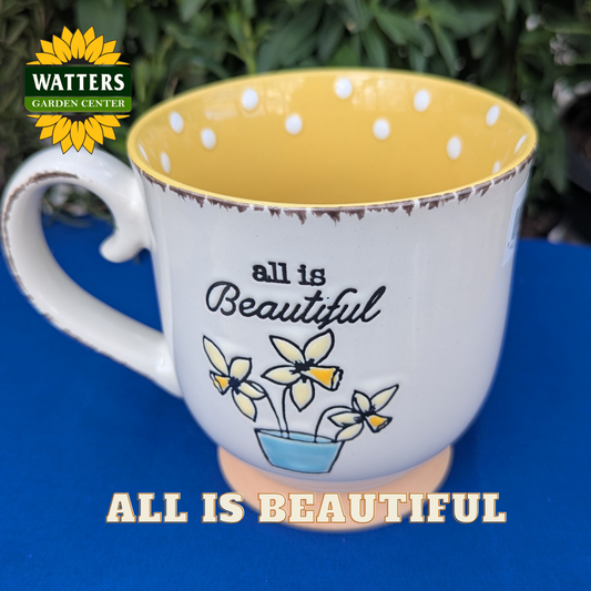 Mug with 'all is Beautiful' text and polka dot interior on a blue background, Watters Garden Center logo visible.
