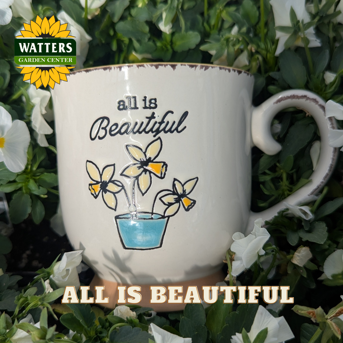 Mug with 'all is Beautiful' text and flower design, surrounded by greenery and flowers, with Watters Garden Center logo.