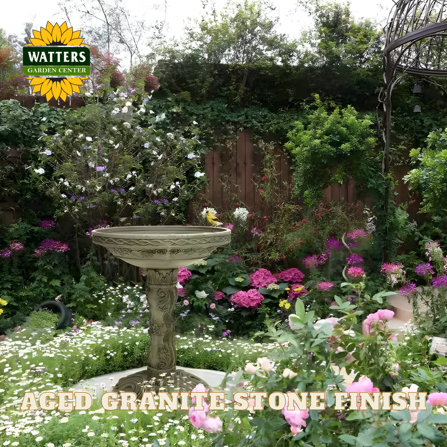 Bird bath in a garden with Watters Garden Center branding