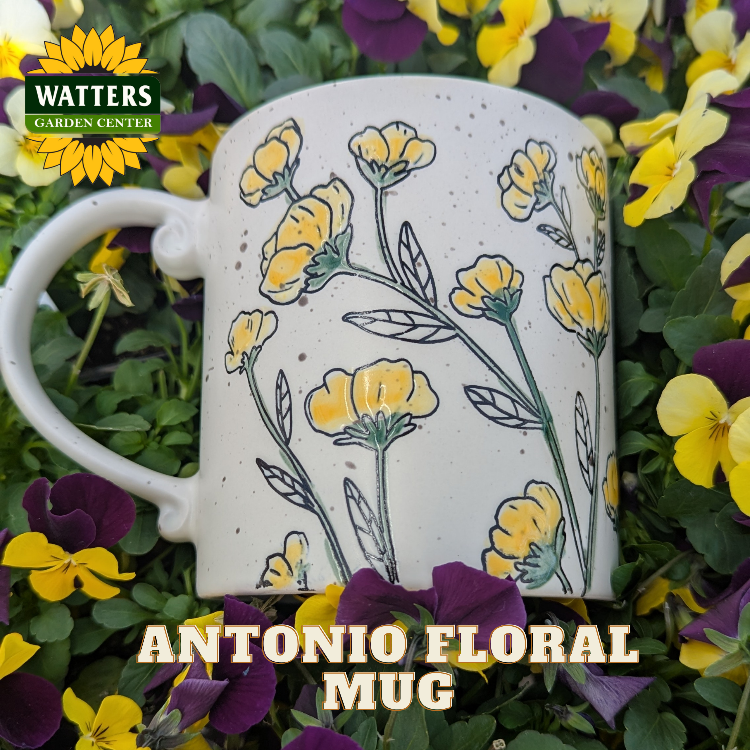 White mug with yellow floral design surrounded by flowers and plants, featuring Watters Garden Center logo.