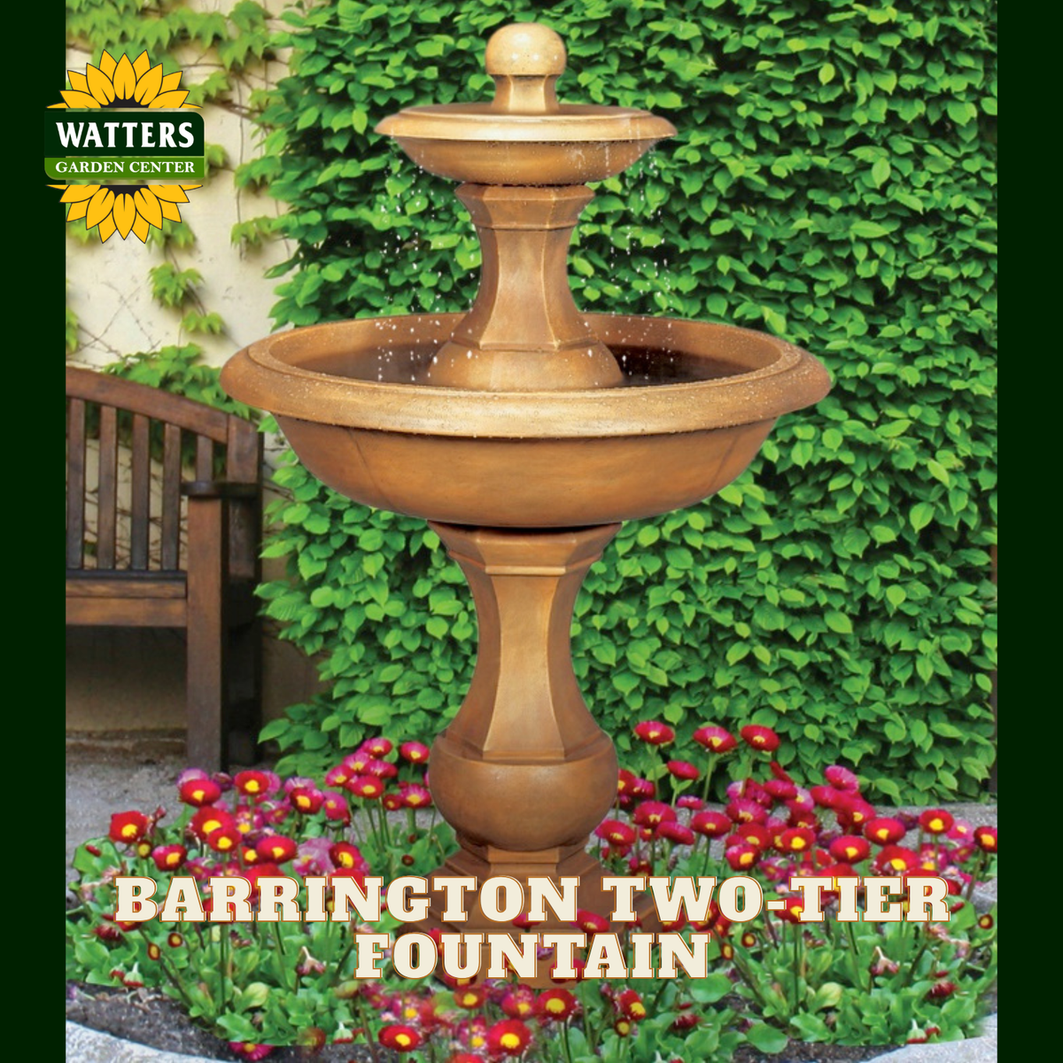 A two-tier outdoor garden fountain with a warm bronze finish, shown in a landscaped garden setting with red flowers, green ivy, and a wooden bench. The Watters Garden Center logo is in the top-left corner, and the text 'BARRINGTON TWO-TIER FOUNTAIN' is overlaid at the bottom.