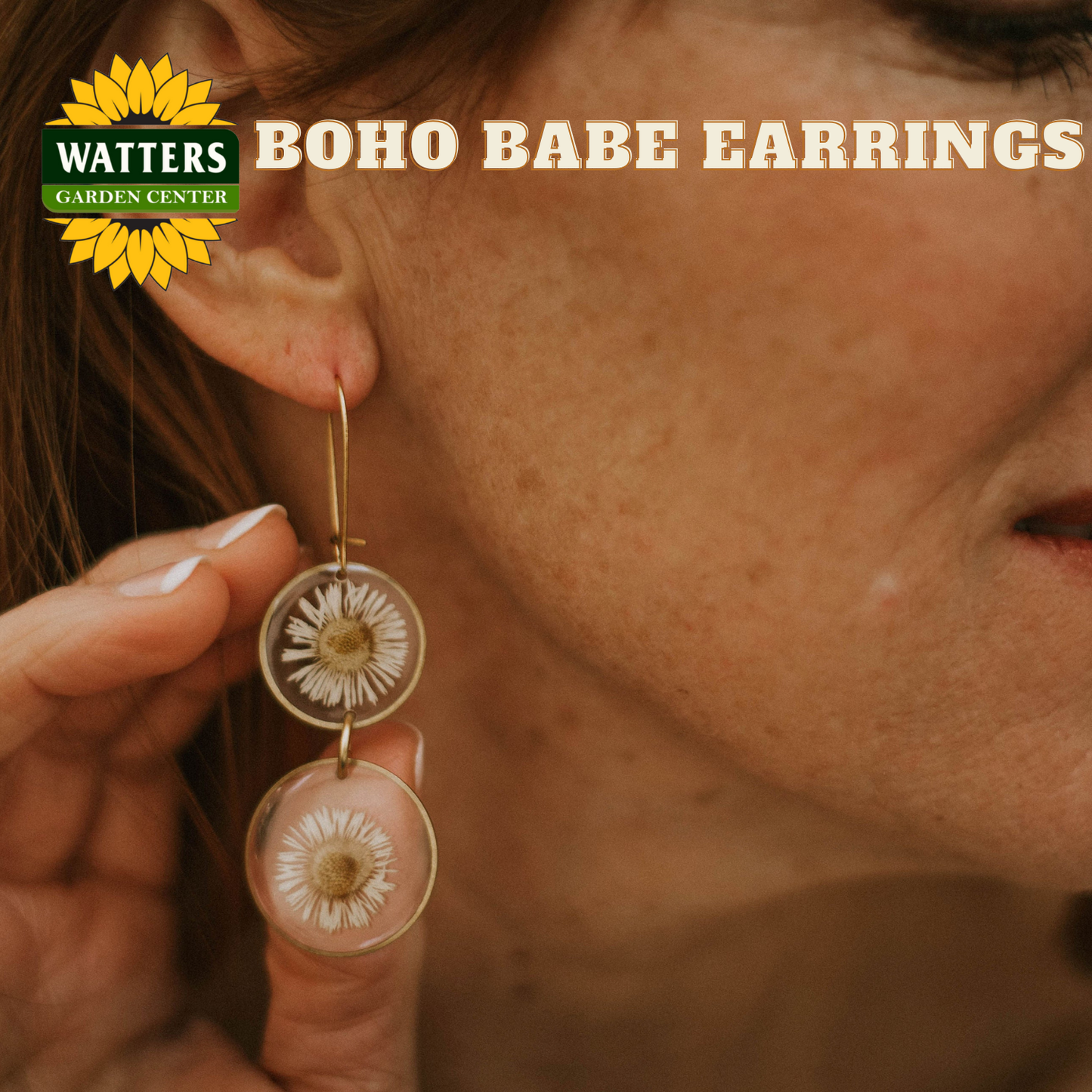 Close-up of a woman wearing Watters Boho Babe earrings with the brand logo.