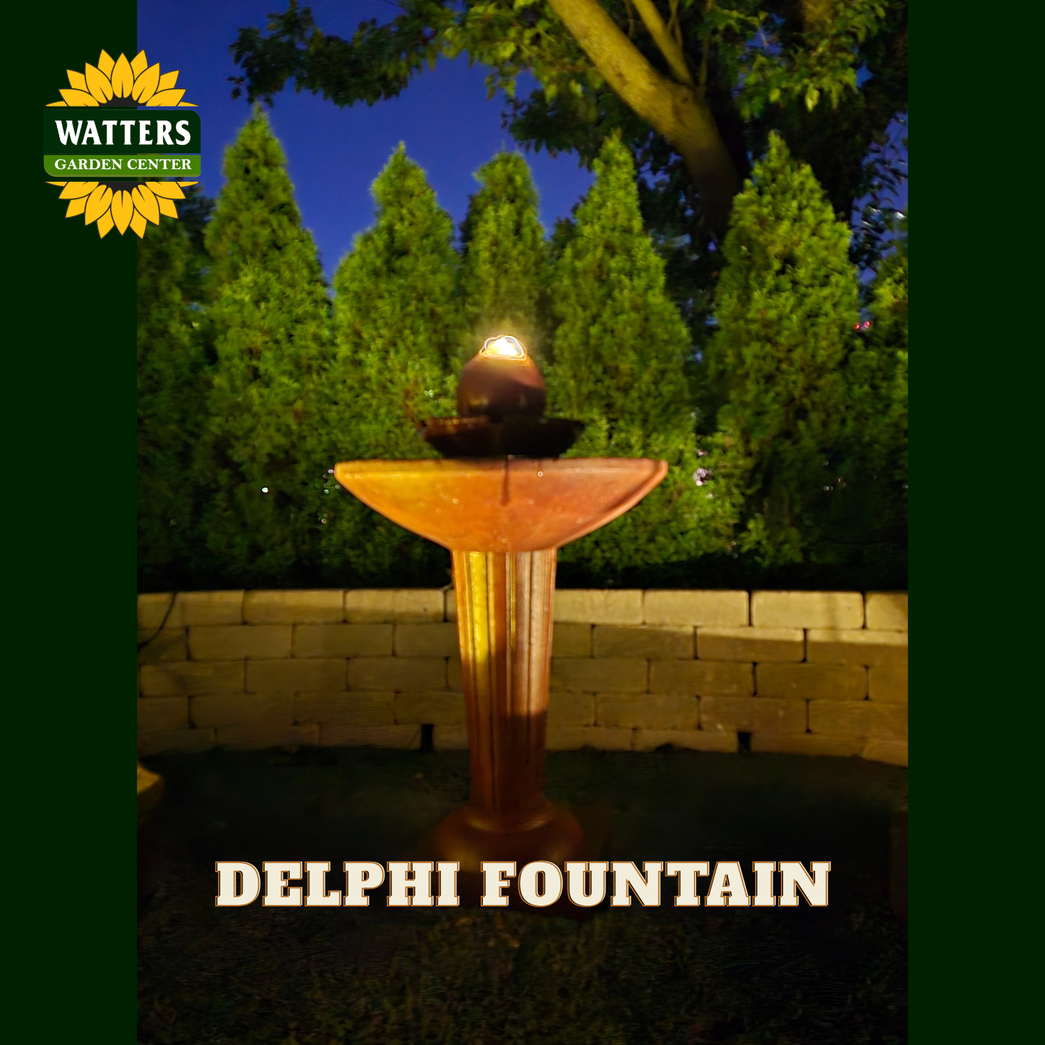 An outdoor Delphi fountain illuminated at dusk, with a glowing orb above a tiered basin. The fountain is shown in a landscaped garden setting with trees and a low stone wall.