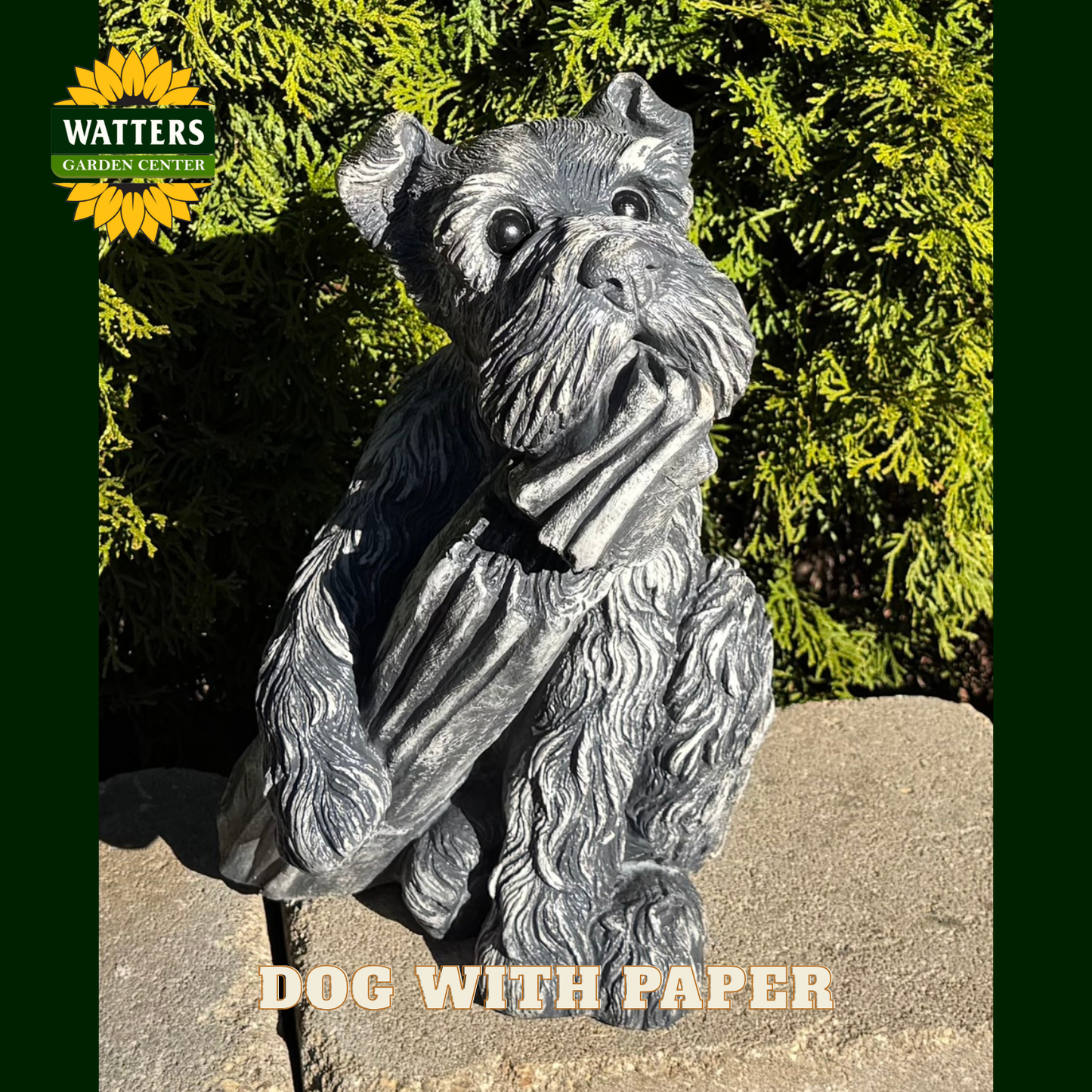 Dog holding a paper statue in a garden.