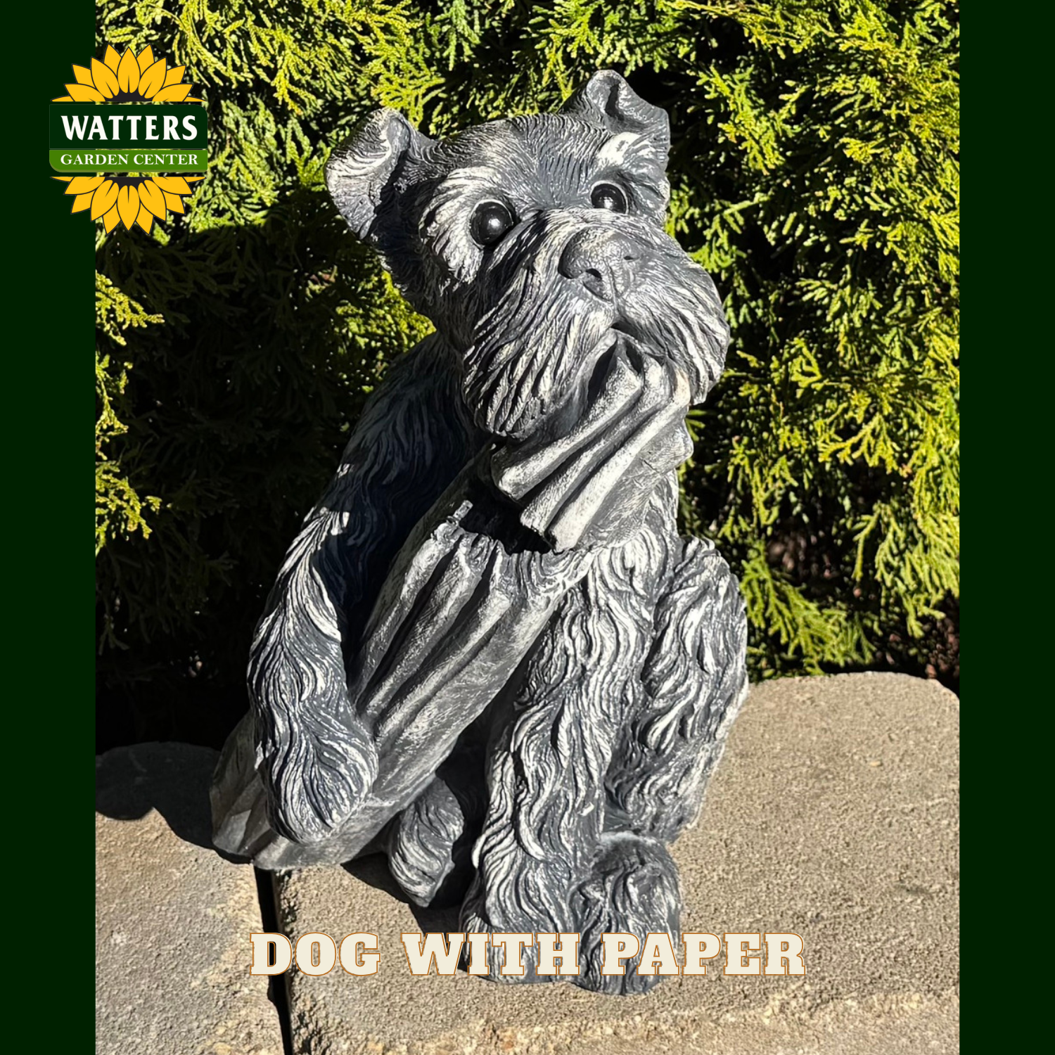 Dog holding a paper statue in a garden.