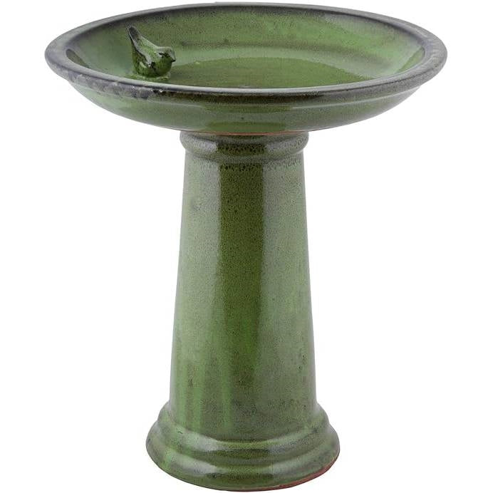 Green ceramic bird bath with a small decorative bird on a white background