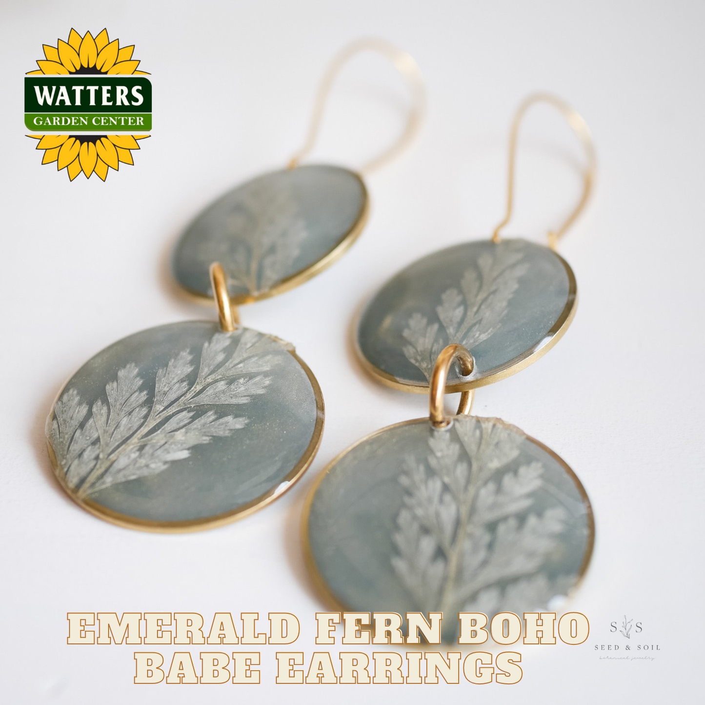 Earrings with fern design on a white background, featuring Watters Garden Center logo.