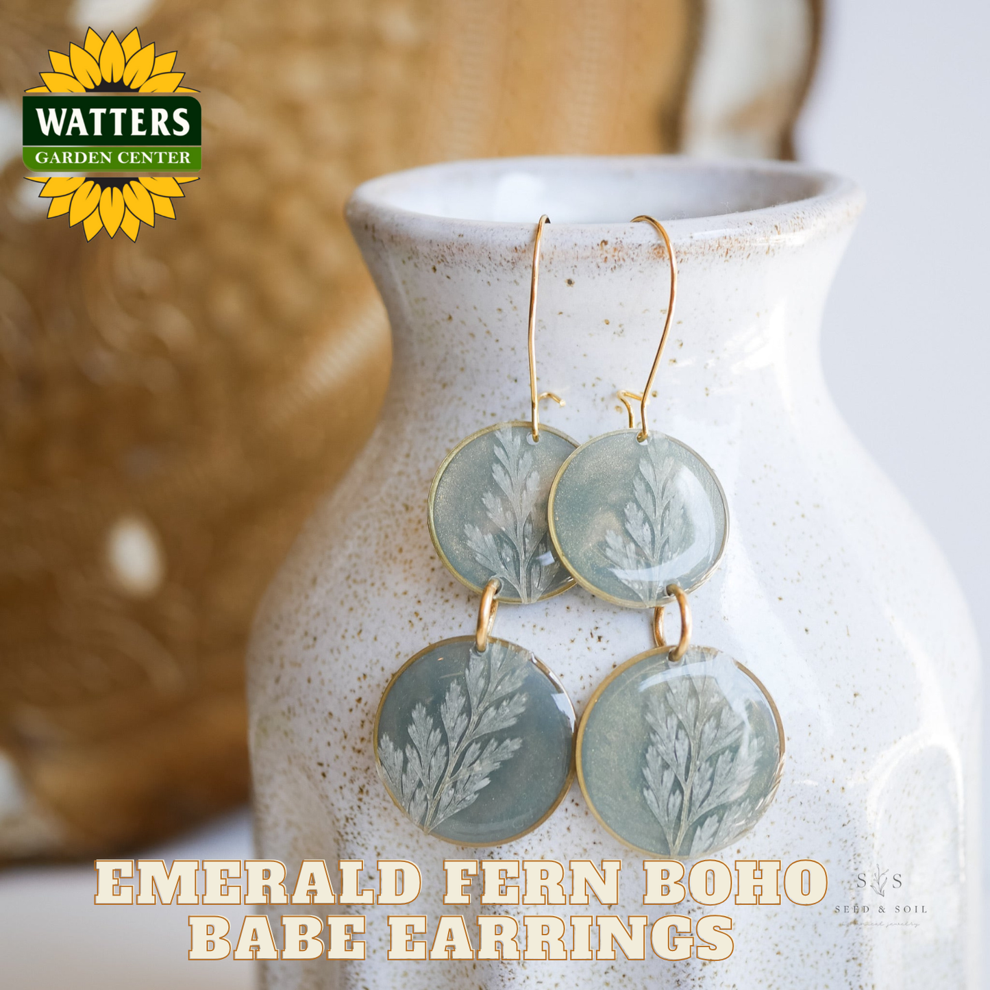 Earrings with leaf design on a ceramic vase, featuring Watters Garden Center branding.