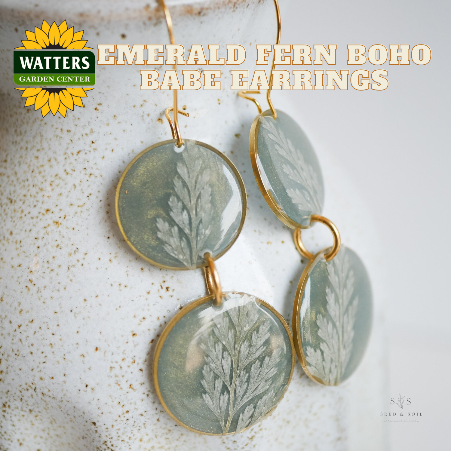 Emerald Fern Boho Babe earrings with Watters Garden Center logo on a textured surface.
