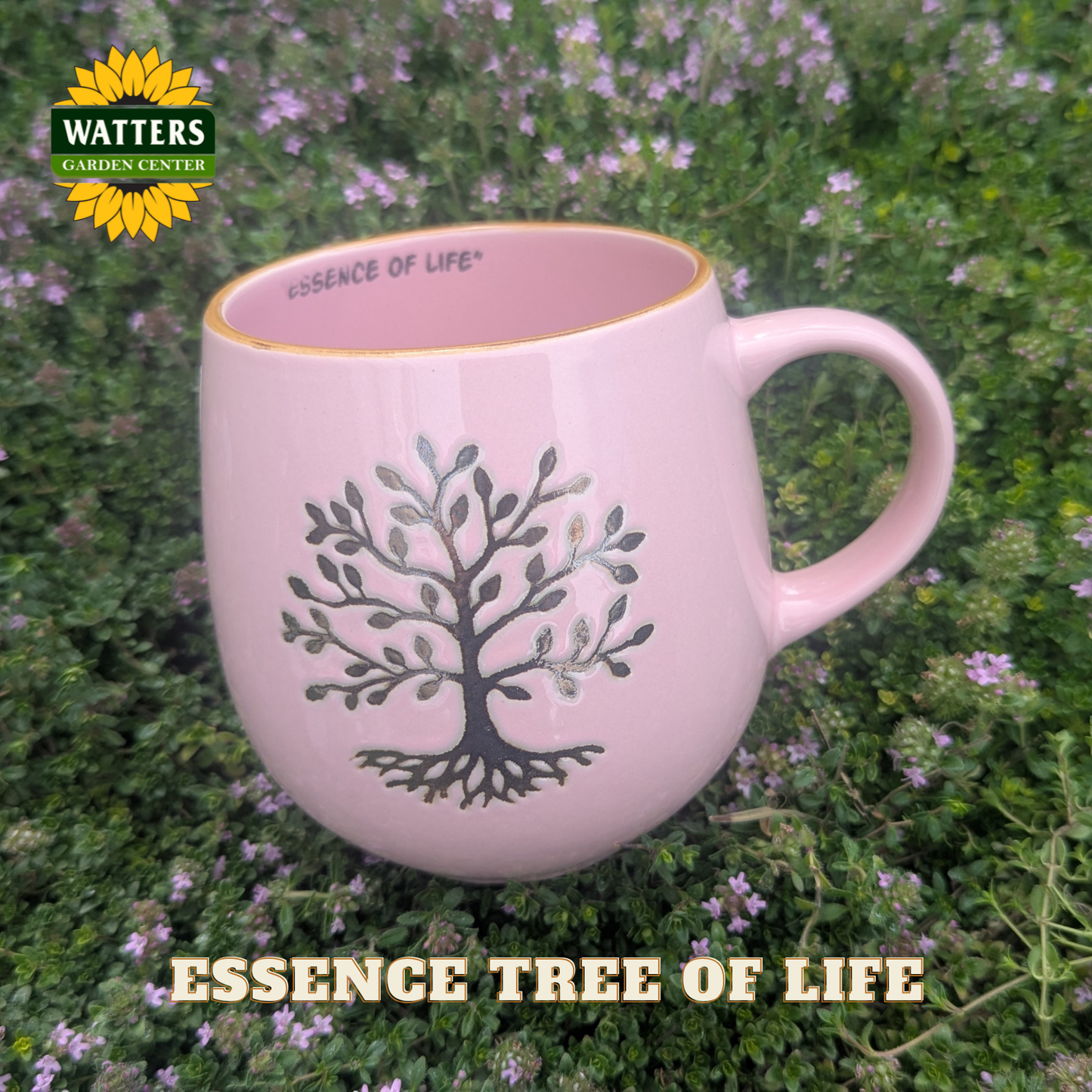 Pink mug with 'Essence of Life' design on a green background with flowers