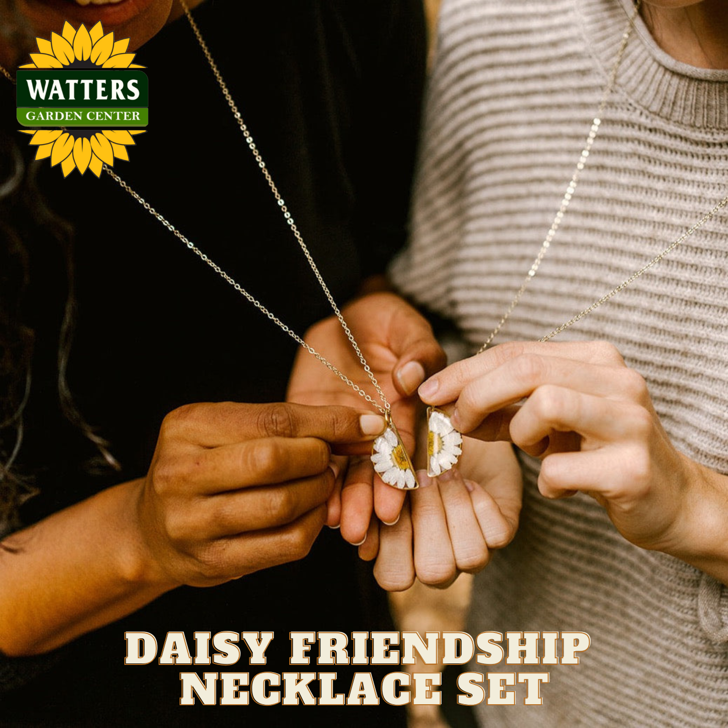 Two people holding a daisy friendship necklace set with Watters Garden Center branding.