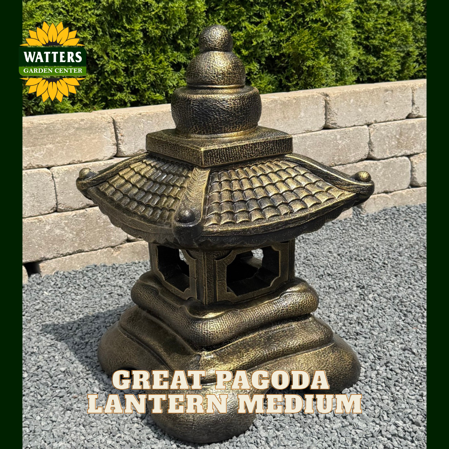 A bronze-finished Great Pagoda Lantern from Watters Garden Center, shown outdoors on a gravel surface with a stone wall and green shrubs in the background. The image features a dark green border and text overlays reading 'WATTERS GARDEN CENTER' and 'GREAT PAGODA LANTERN MEDIUM'.