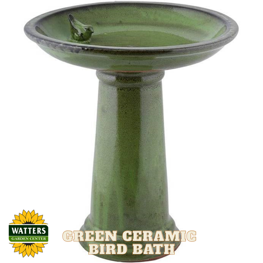 Green ceramic bird bath with a small bird figure on a white background, featuring Watters Garden Center logo.