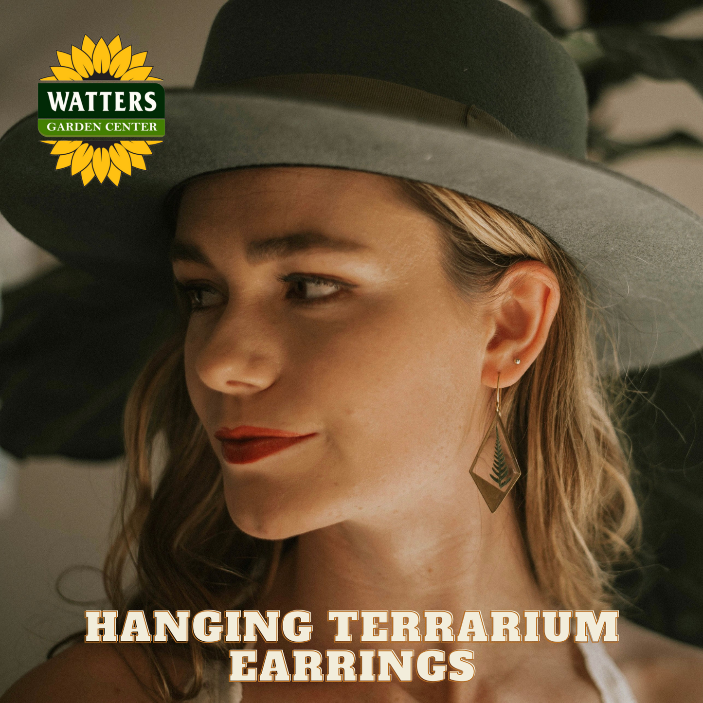 Woman wearing a wide-brimmed hat with 'Watters Garden Center' logo and text about hanging terrarium earrings.