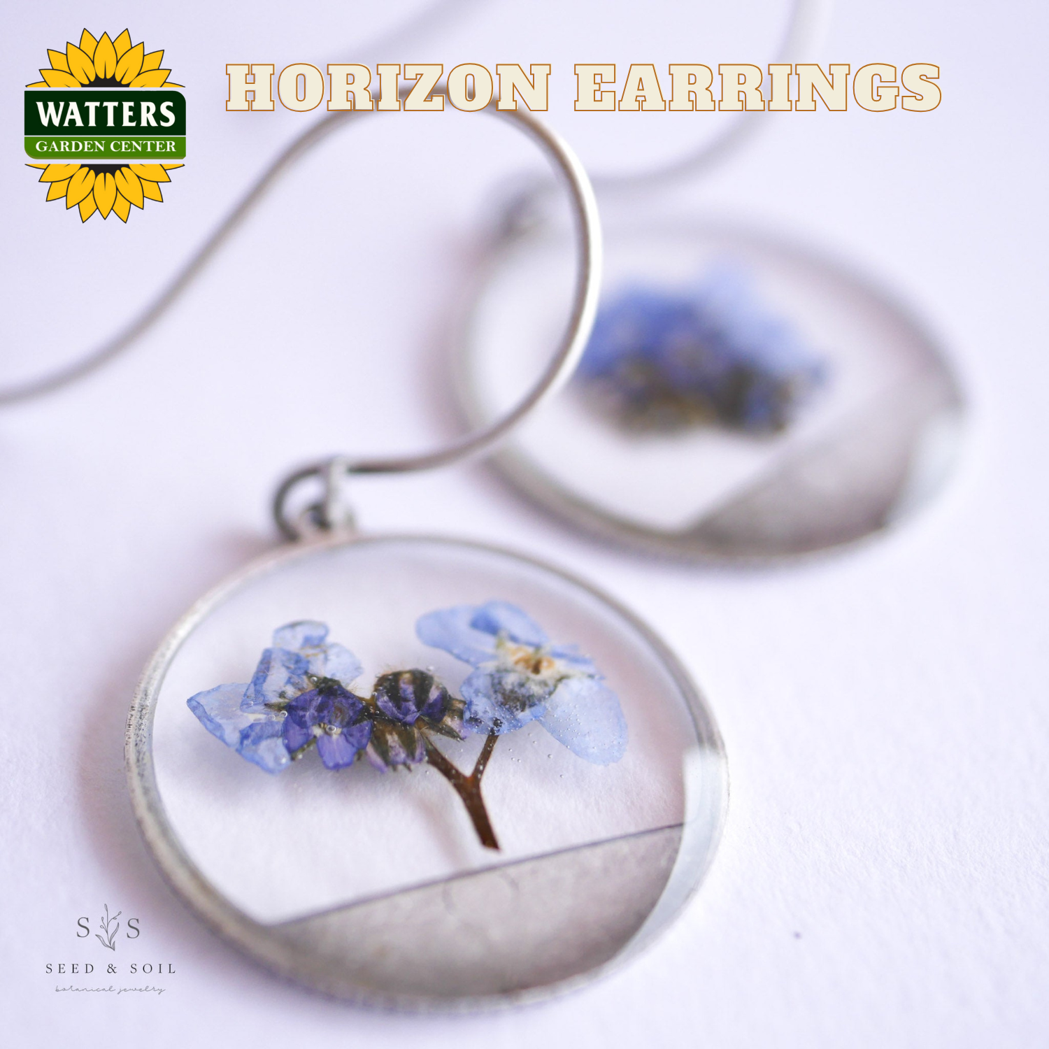 Earrings with pressed flowers on a white background, featuring Watters Garden Center logo.