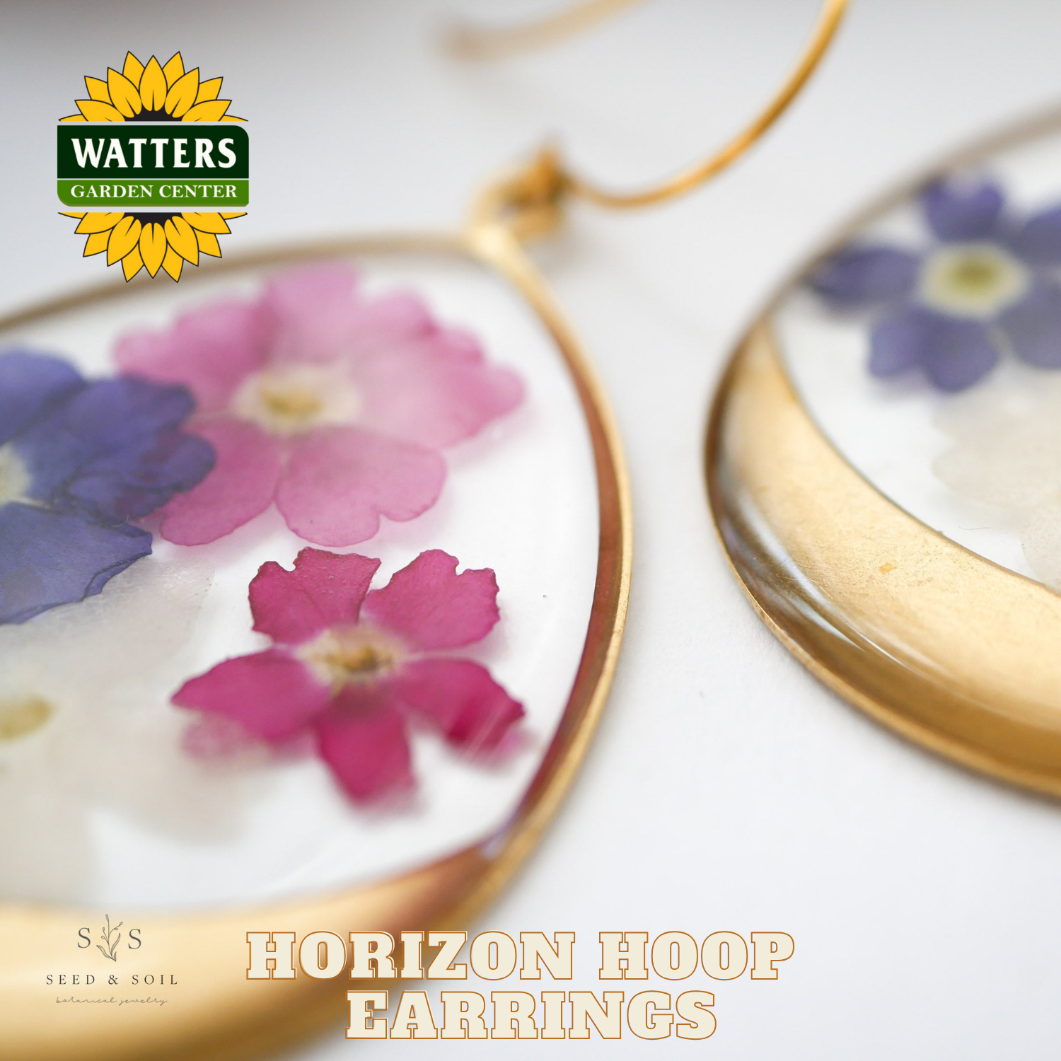 Horizon hoop earrings with floral design on a white background, featuring Watters Garden Center logo.