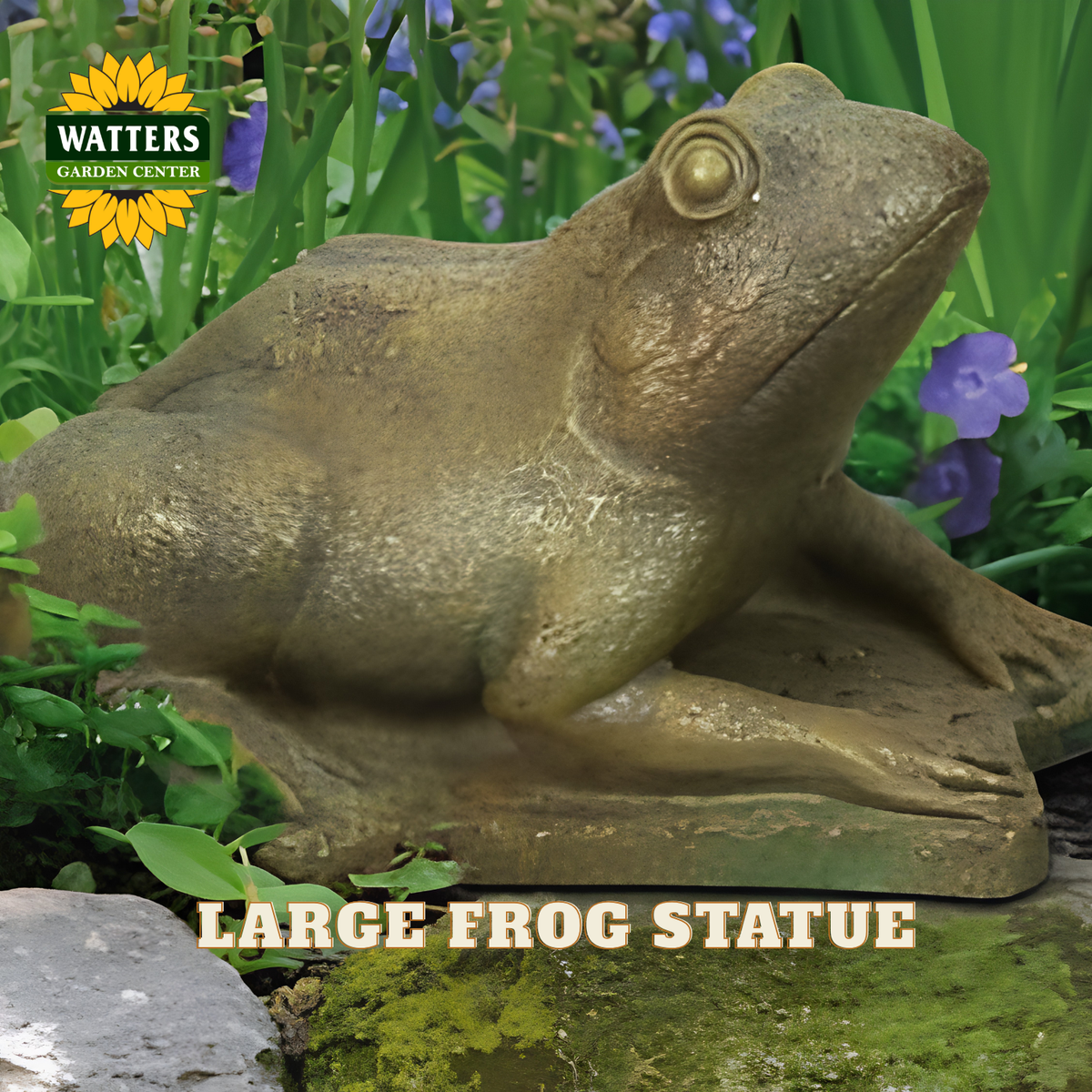 A large realistic frog garden statue in a mossy green stone-like finish, shown sitting outdoors among grass, purple flowers, and a pond surface. The Watters Garden Center logo appears in the top left, and the text 'LARGE FROG STATUE' is overlaid at the bottom.