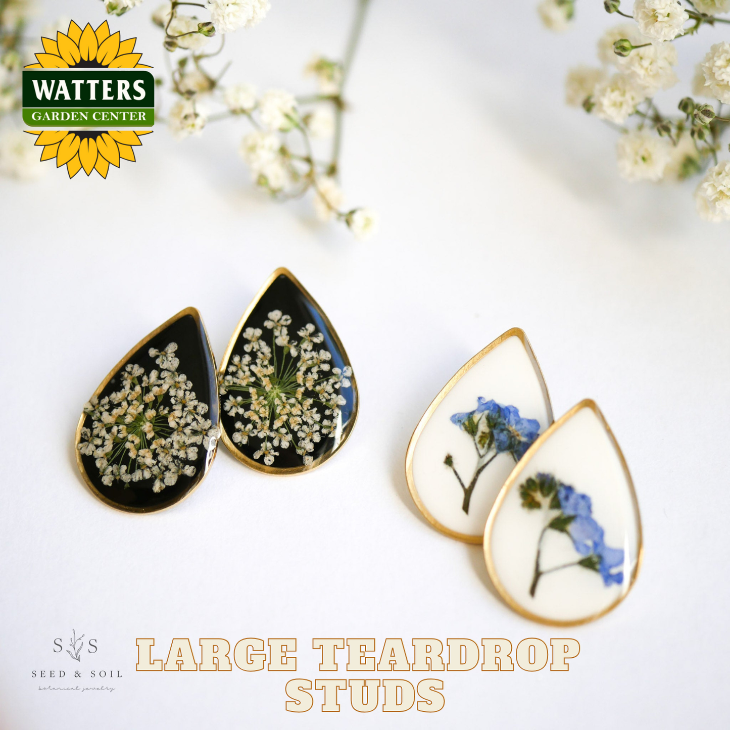 Teardrop-shaped earrings with pressed flowers on a white background, featuring Watters Garden Center logo.