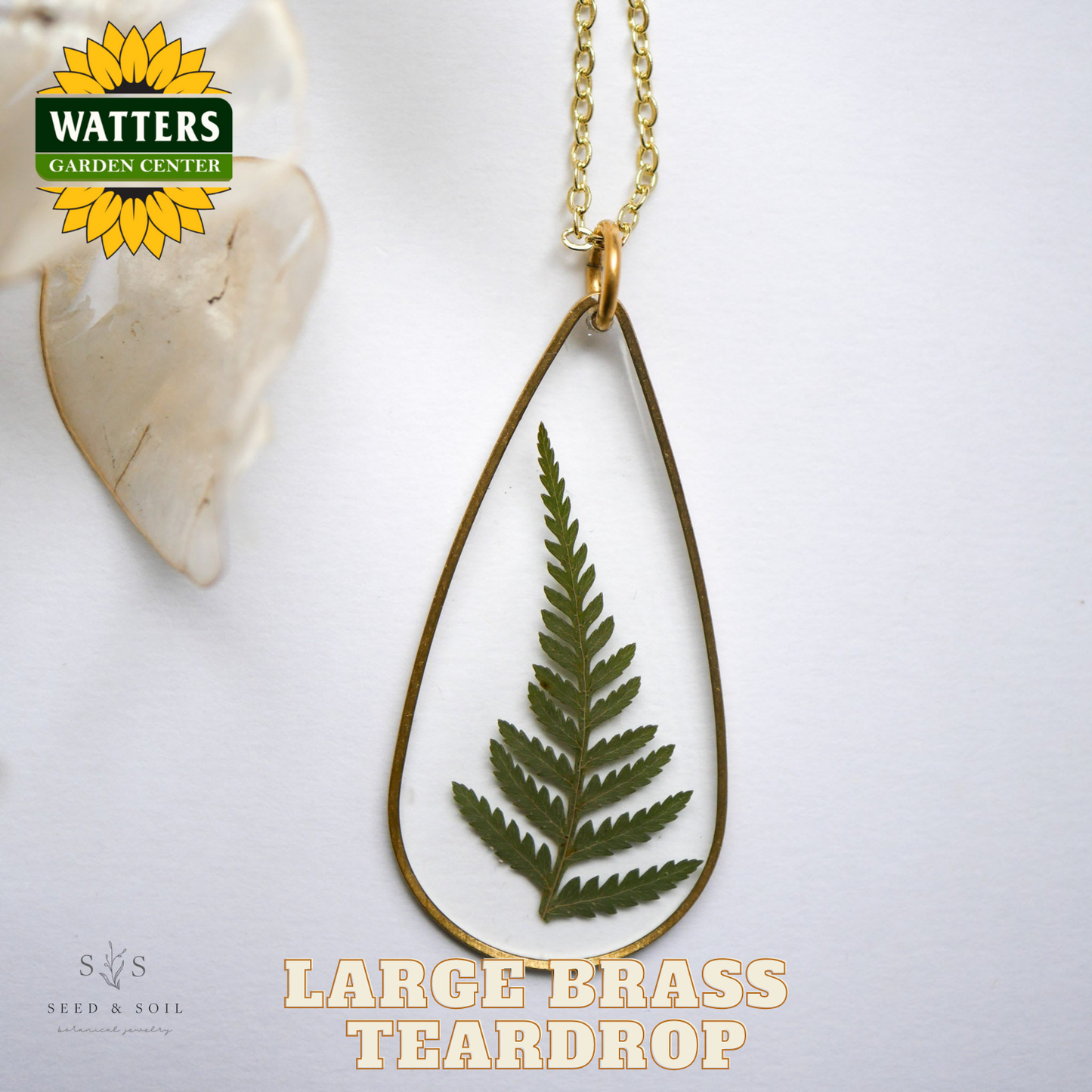 Teardrop-shaped necklace with a leaf design on a white background, featuring Watters Garden Center logo.