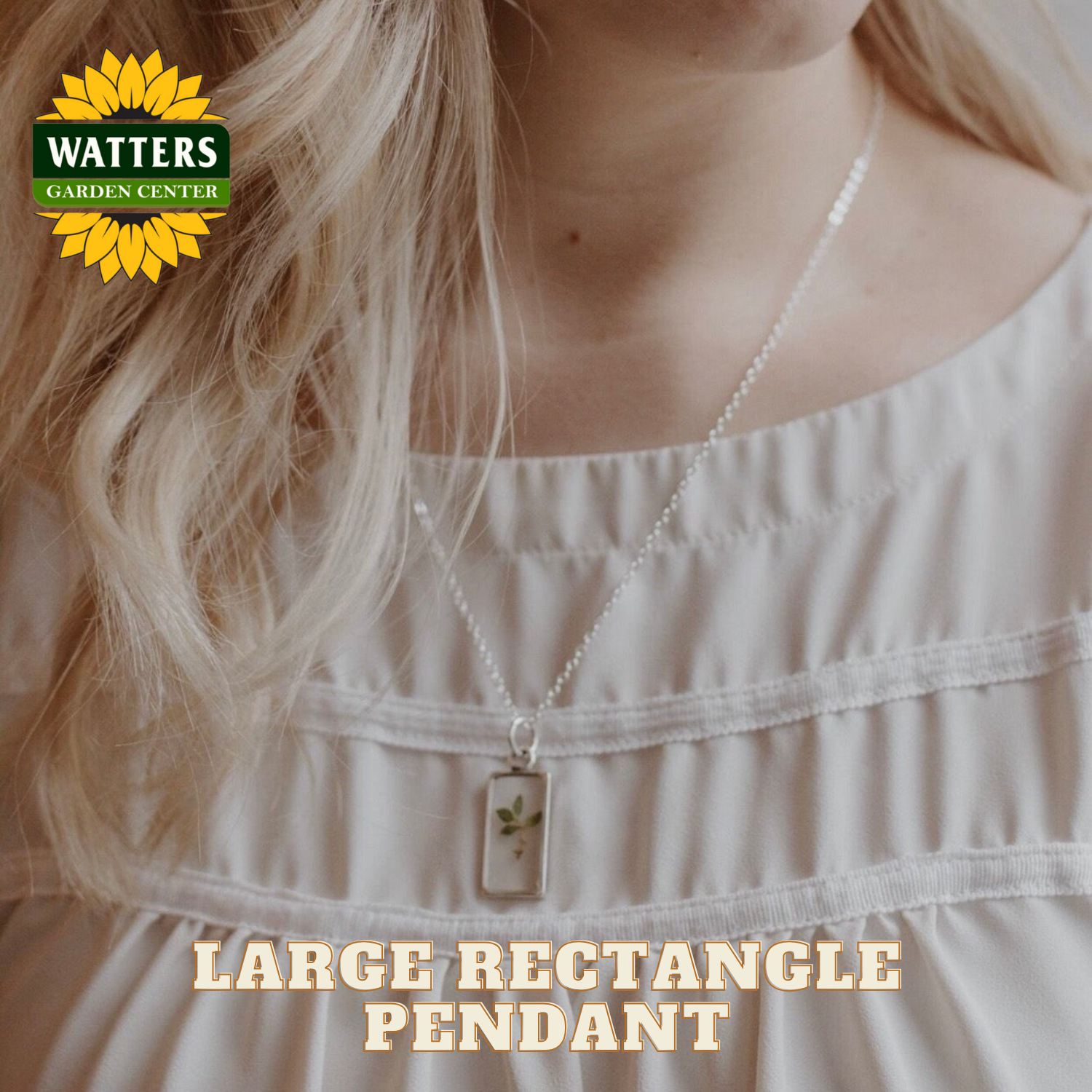 Person wearing a necklace with a large rectangle pendant, Watters Garden Center logo visible.