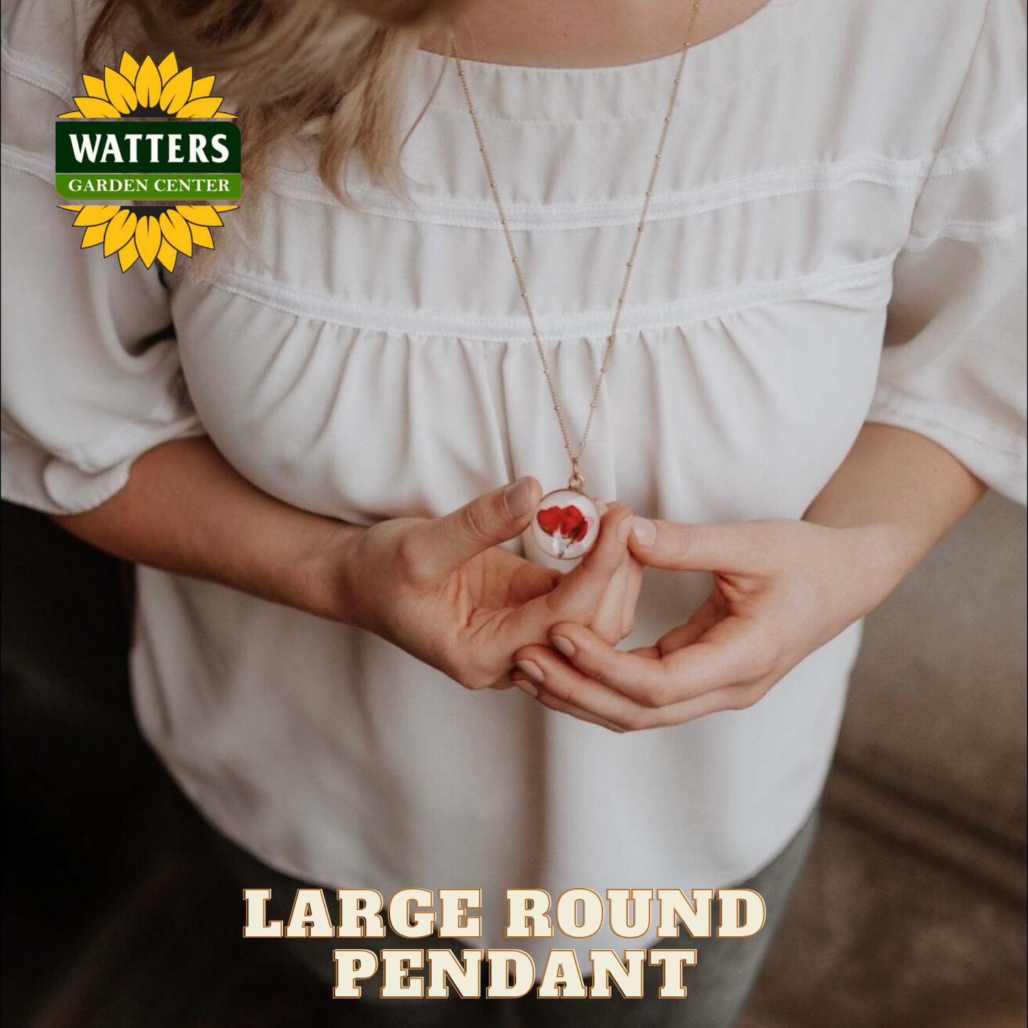 Person wearing a necklace with a large round pendant, Watters Garden Center logo visible.