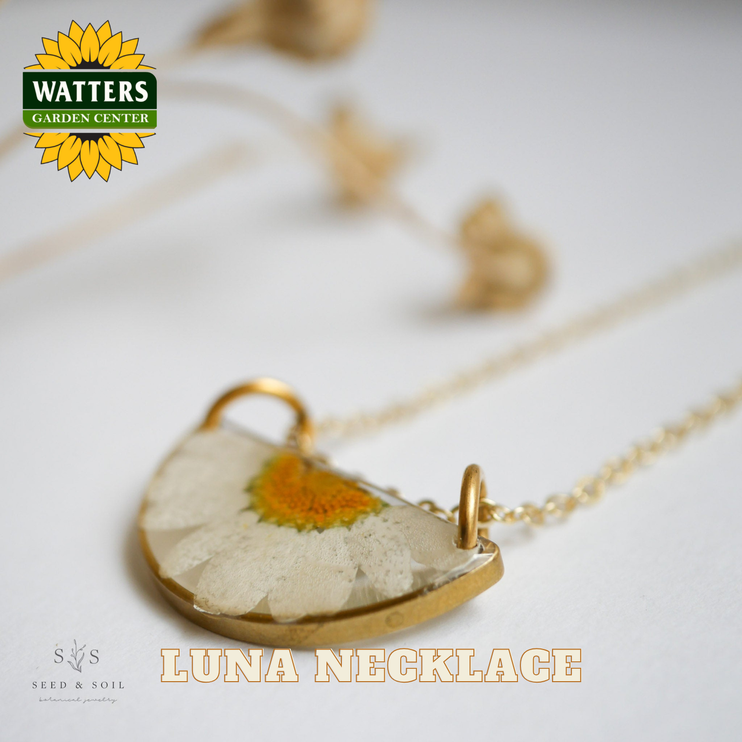 Luna necklace with a pressed flower pendant on a light background, featuring Watters Garden Center logo.