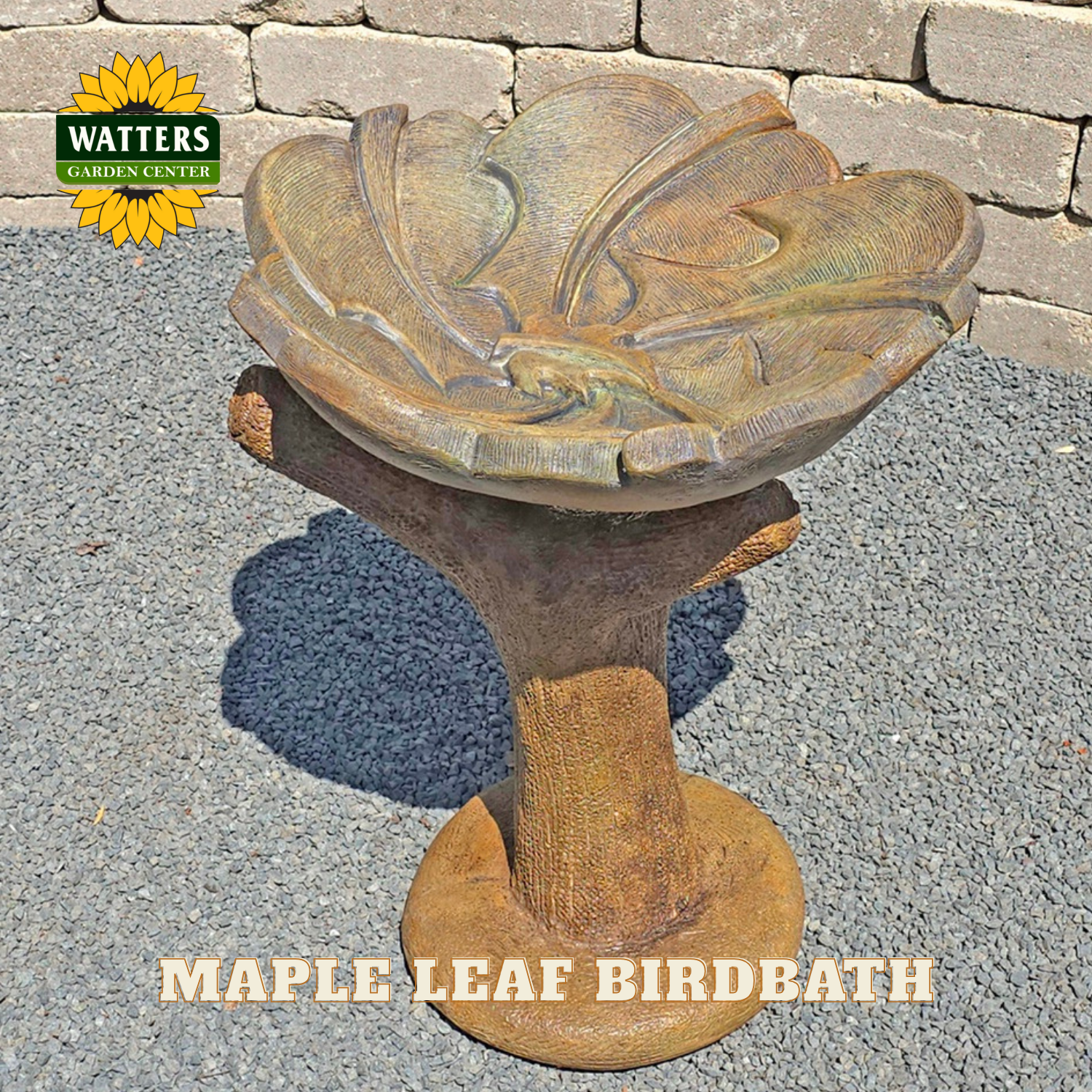 Maple leaf birdbath with Watters Garden Center logo on a stone patio