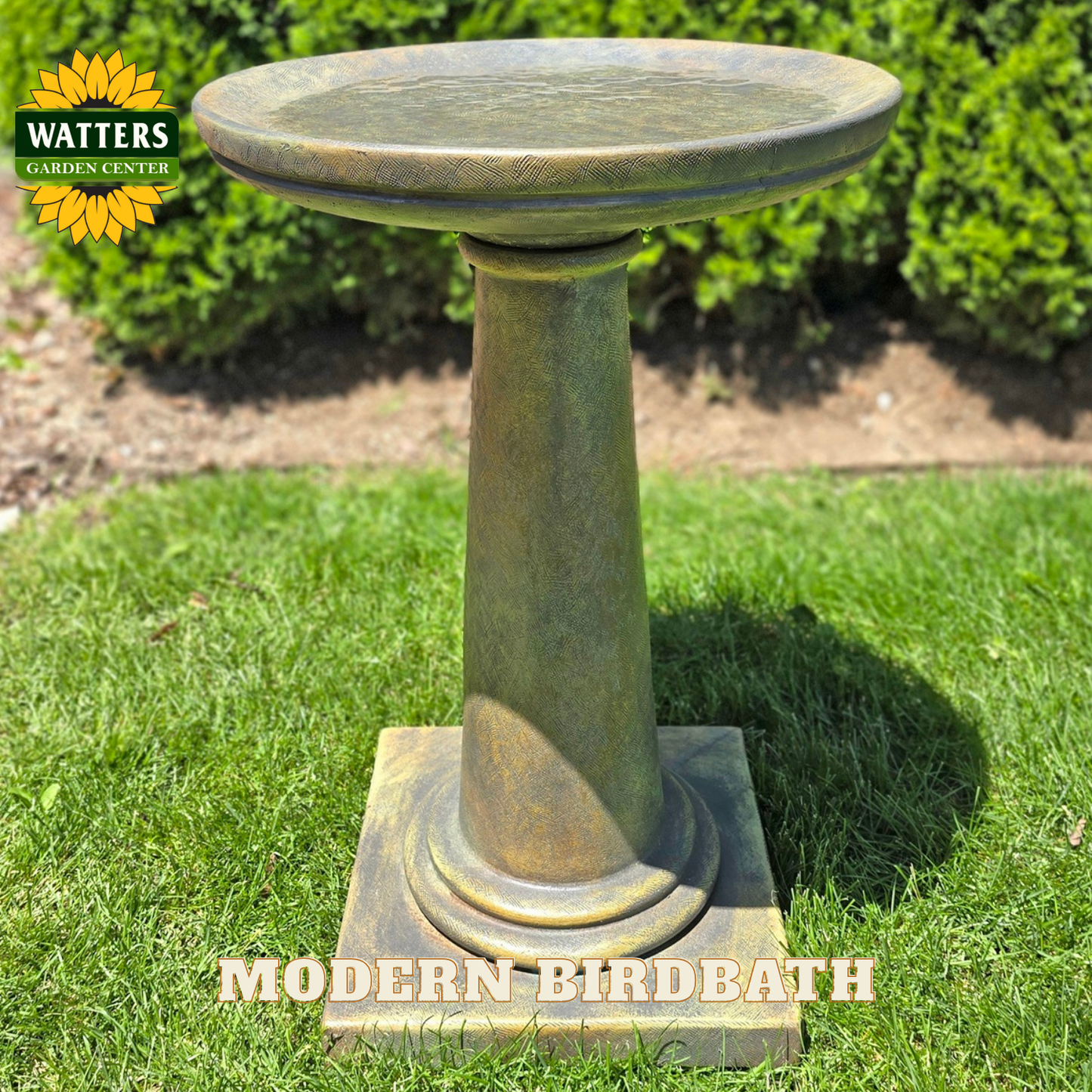 Modern birdbath on grass with Watters Garden Center branding