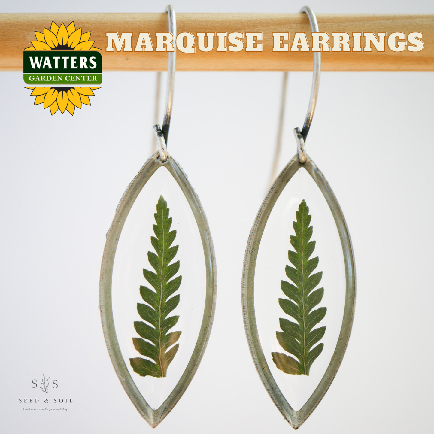 Marquise earrings with leaf design on a white background, featuring Watters Garden Center logo.