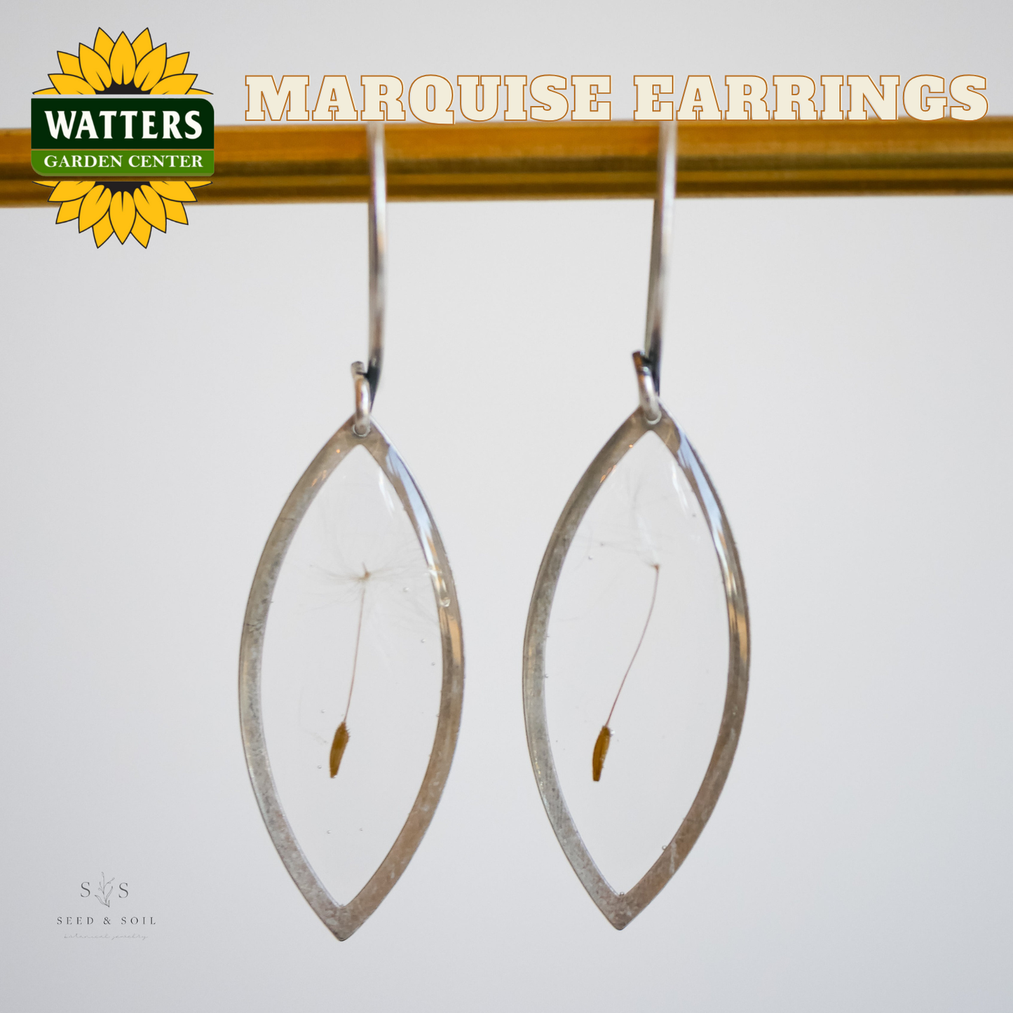 Marquise earrings on a stand with 'Watters Garden Center' branding.