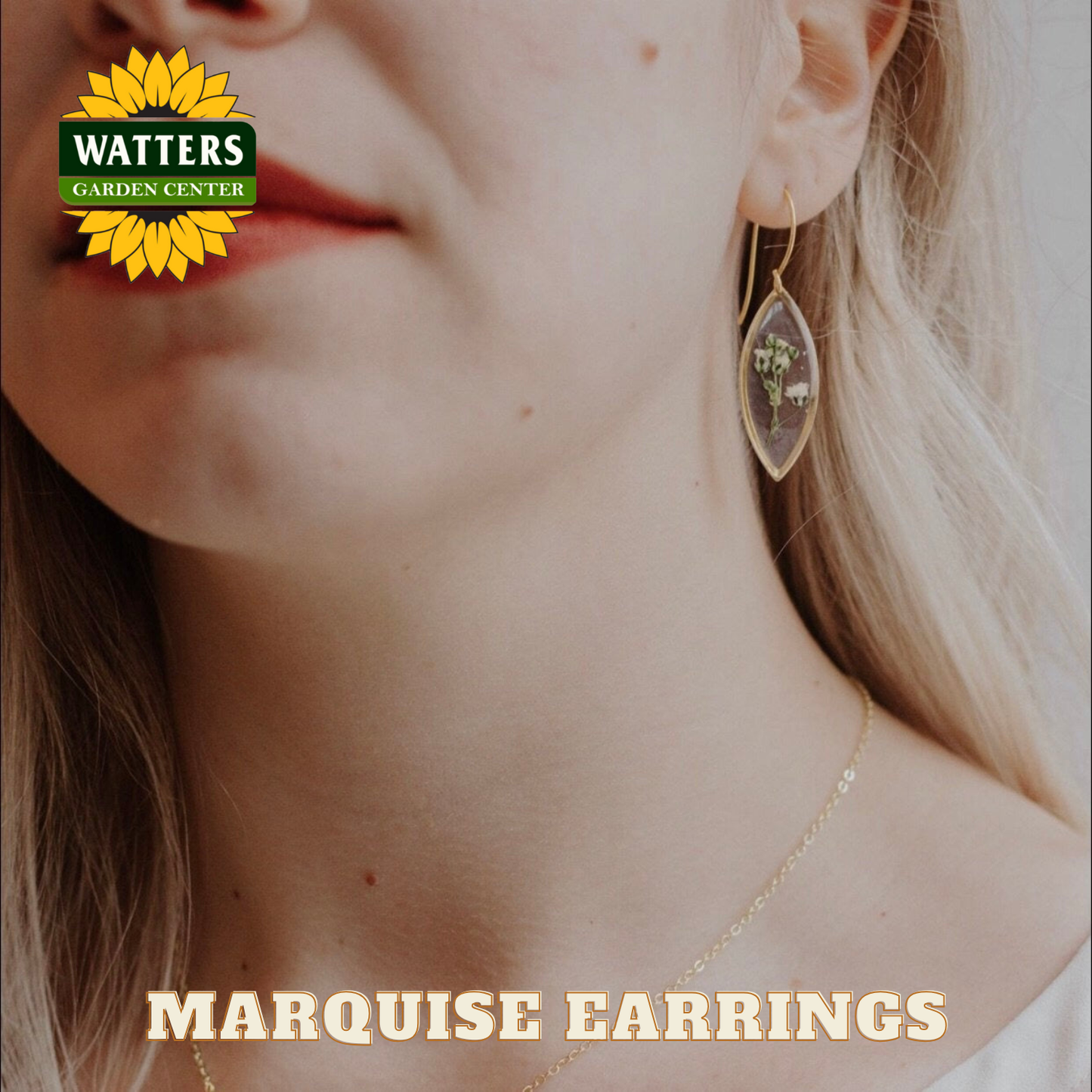 Close-up of a woman wearing marquise earrings with Watters Garden Center logo.
