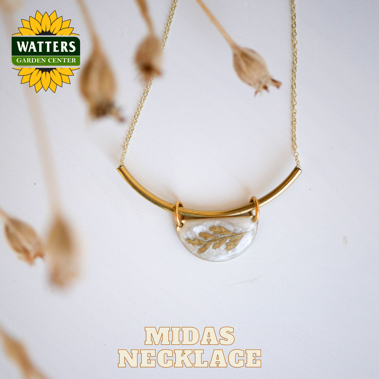 Gold necklace with a clear pendant featuring gold leaves on a white background with Watters Garden Center branding.