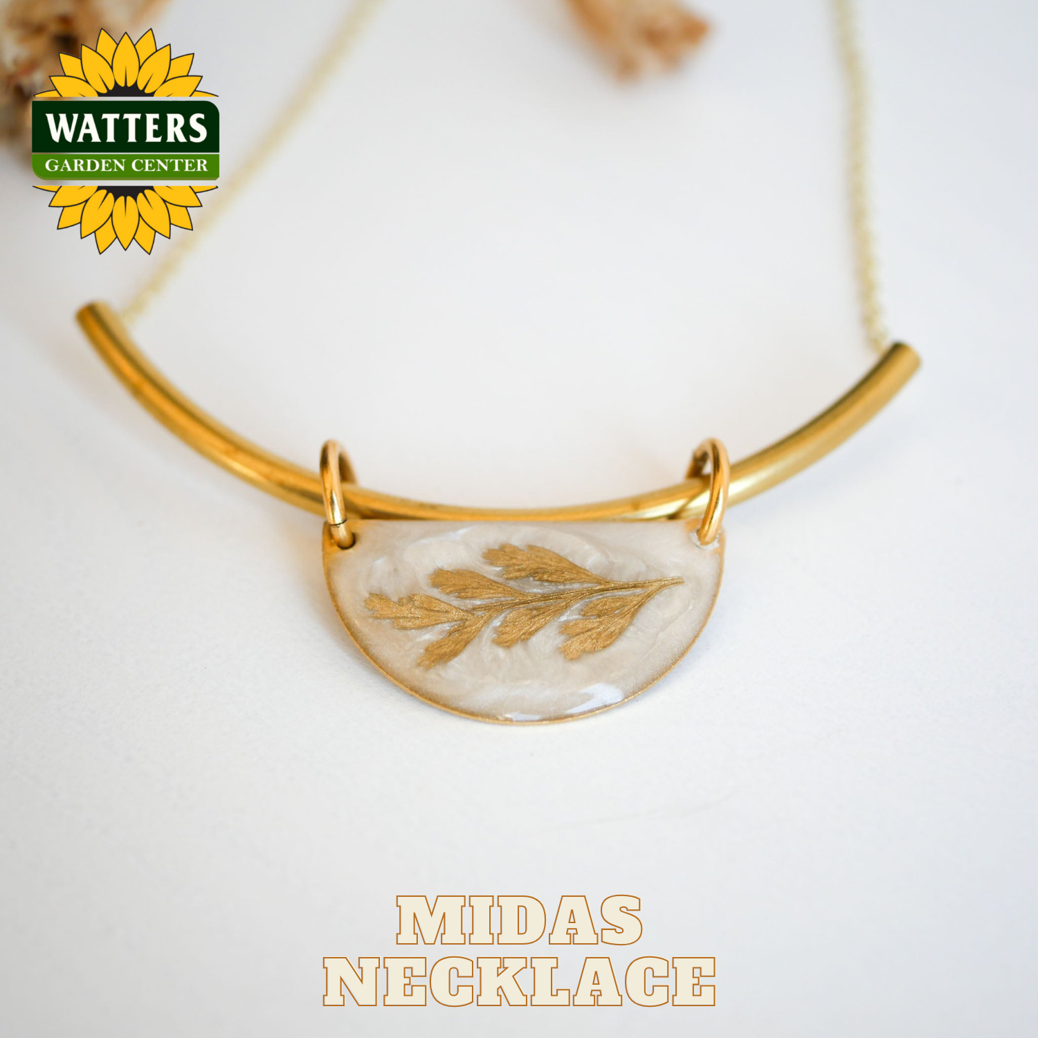 Gold necklace with a leaf pendant on a white background, featuring Watters Garden Center logo.
