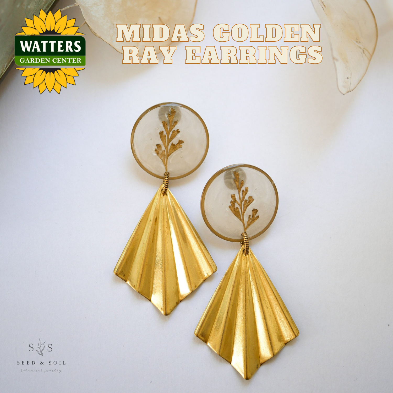 Gold earrings with plant elements on a white background, featuring Watters Garden Center logo.