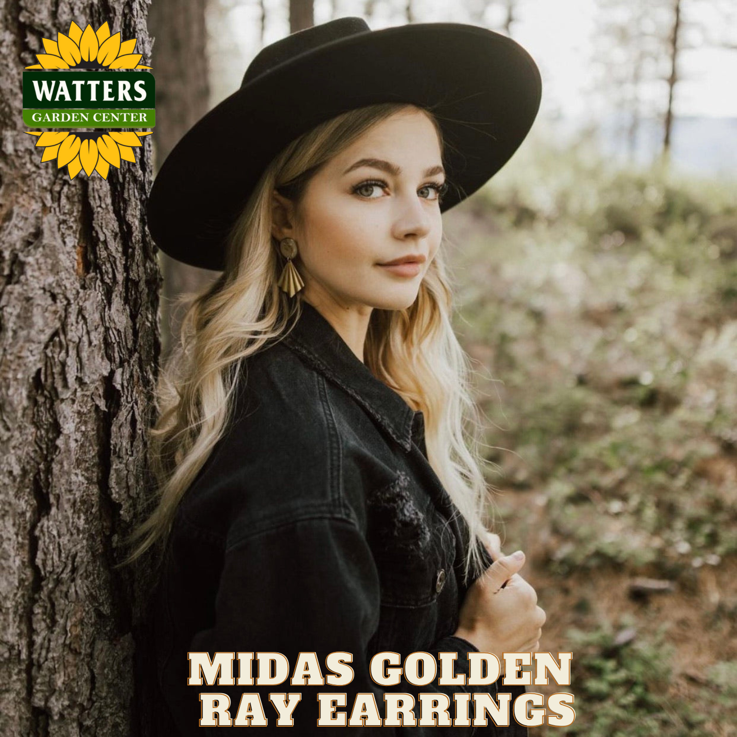 Woman wearing a black hat and earrings in a forest setting with Watters Garden Center branding.