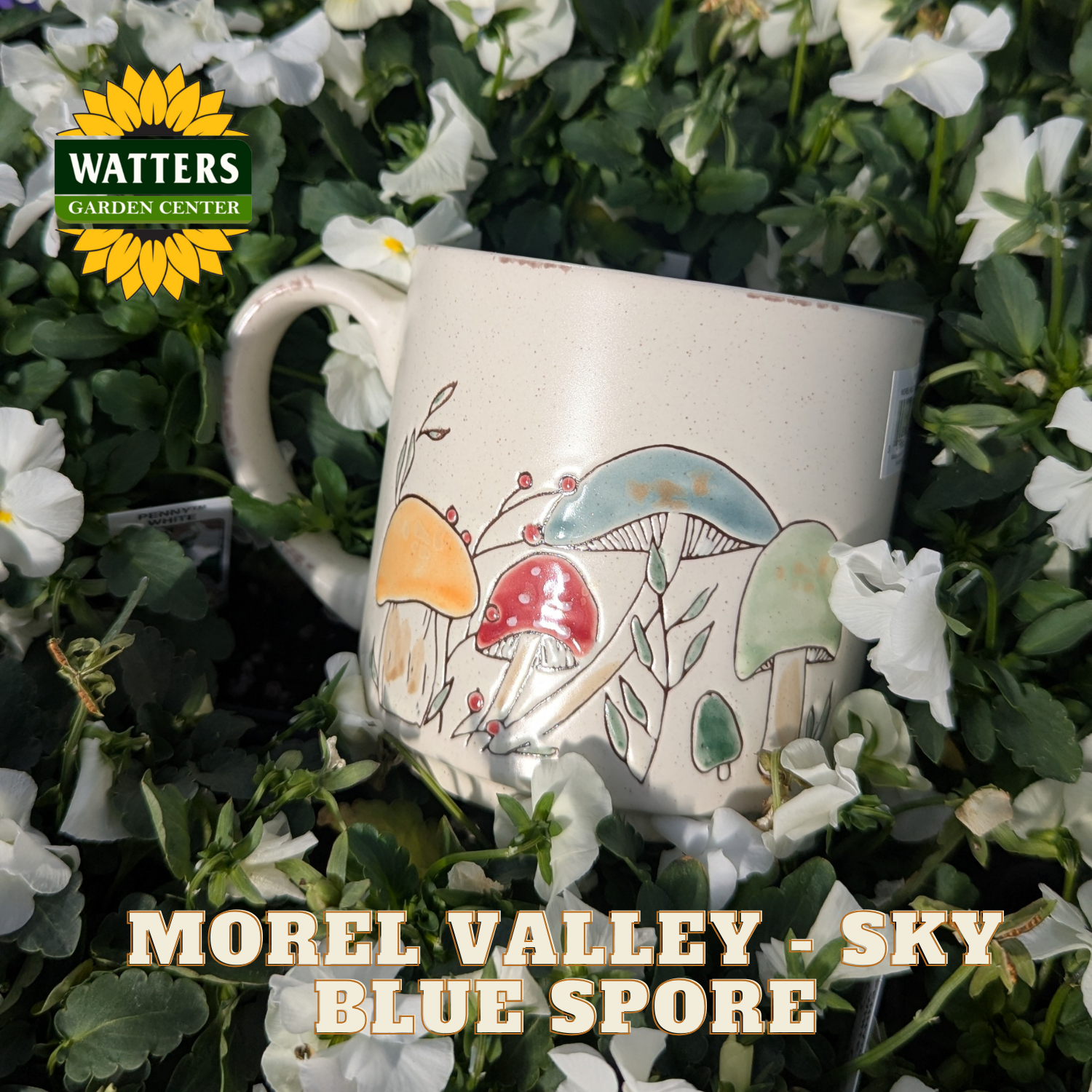 Mug with mushroom design surrounded by greenery and flowers, featuring Watters Garden Center logo.