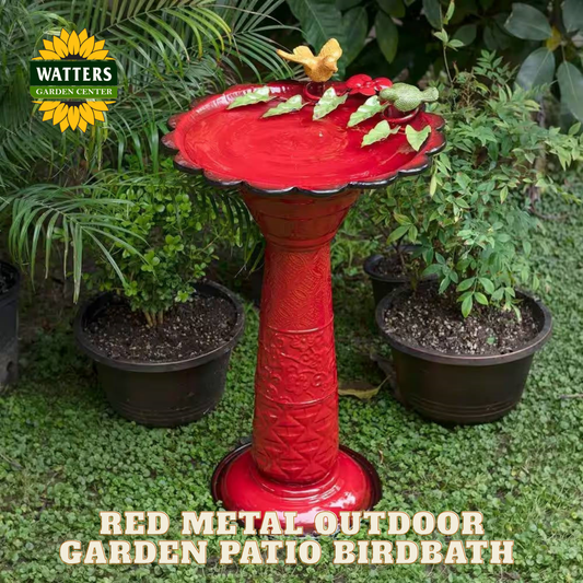 Red metal outdoor garden patio birdbath with decorative elements in a garden setting, featuring Watters Garden Center branding.