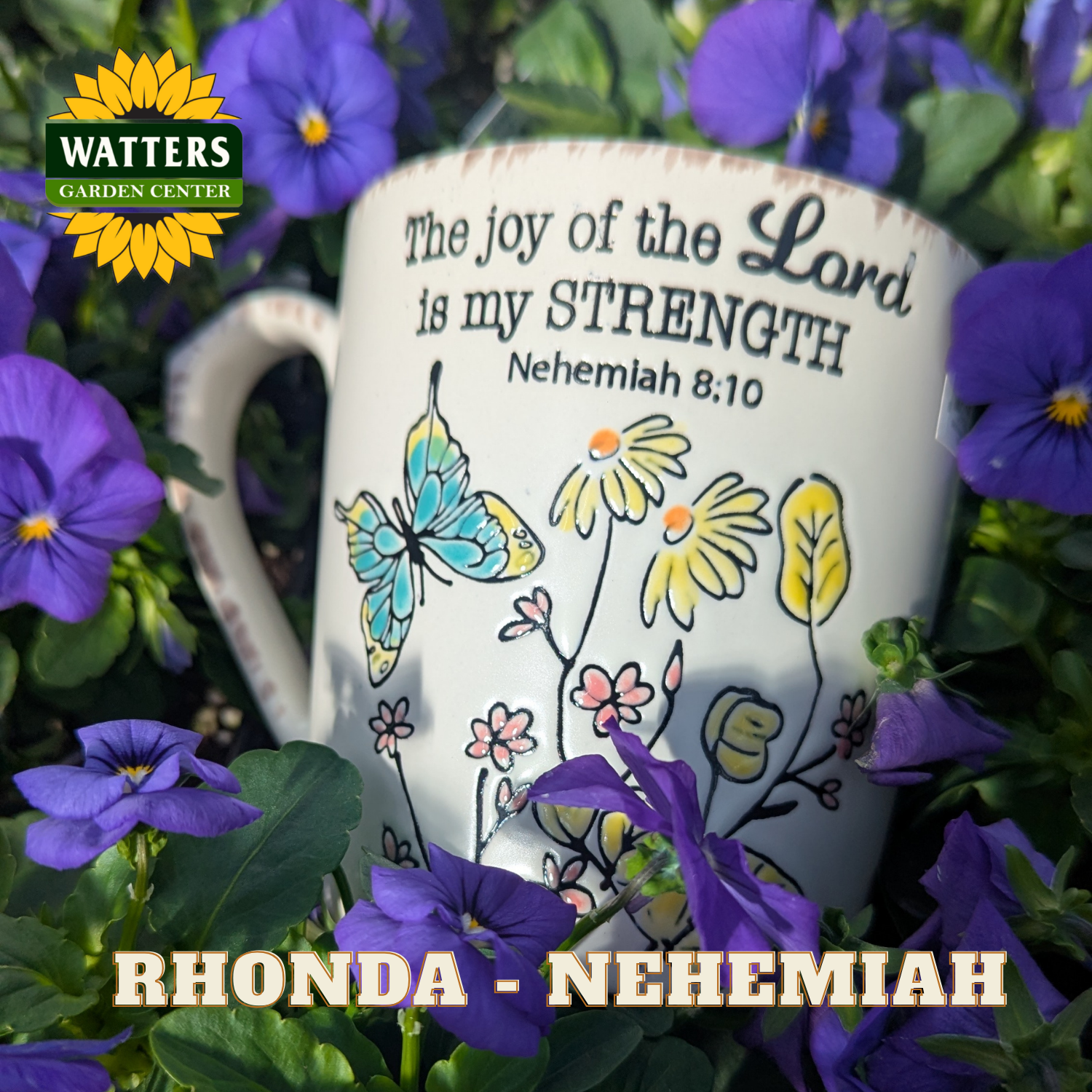 Mug with floral design and Bible verse text surrounded by purple flowers, featuring Watters Garden Center logo.