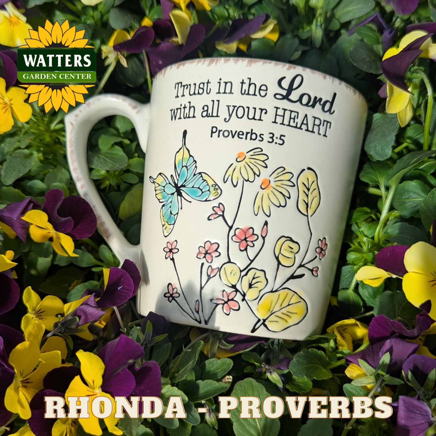 Mug with floral design and motivational quote surrounded by flowers, featuring Watters Garden Center logo.