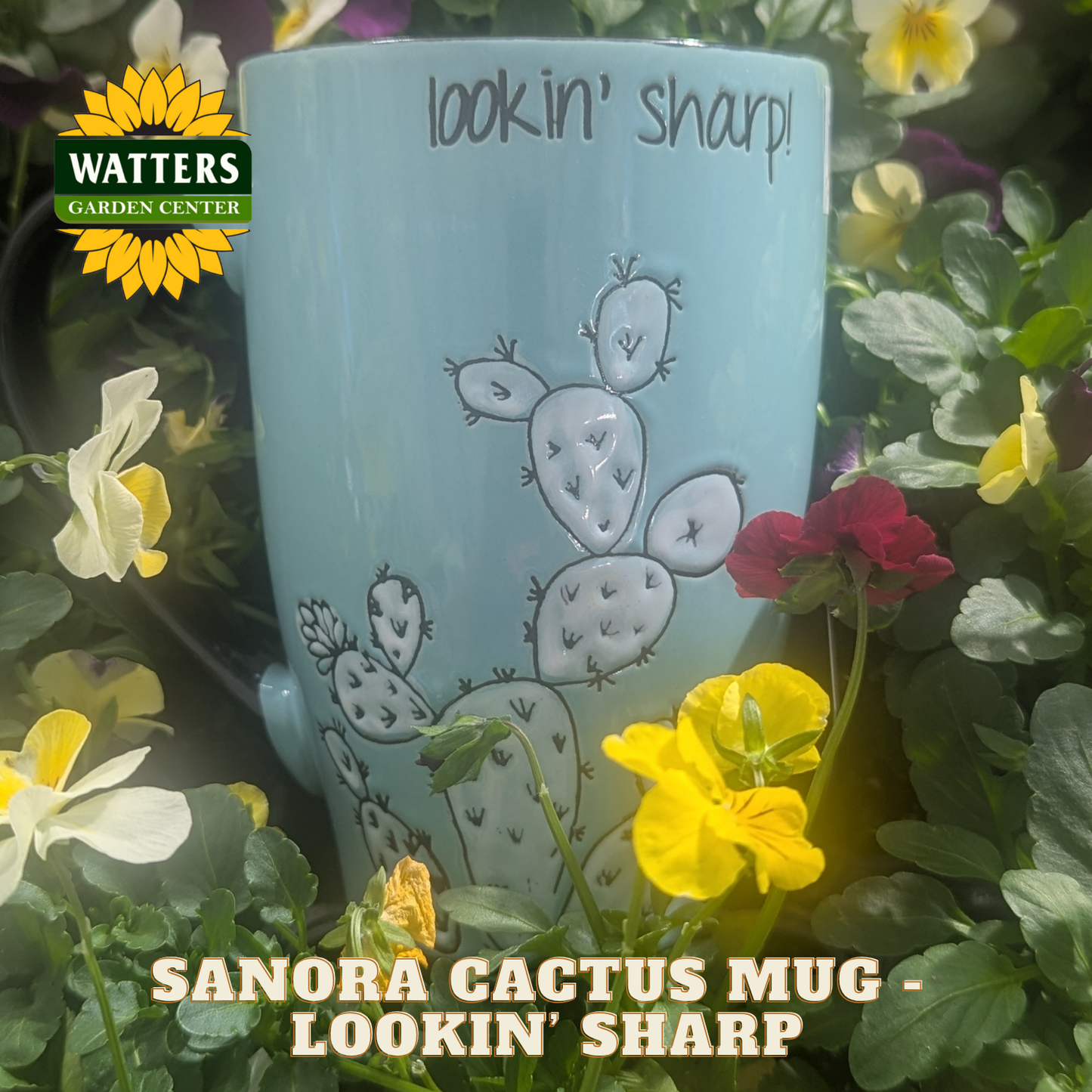 Blue mug with cactus design surrounded by flowers and plants, featuring Watters Garden Center logo.