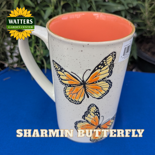 Mug with butterfly design on a blue surface, featuring Watters Garden Center branding.
