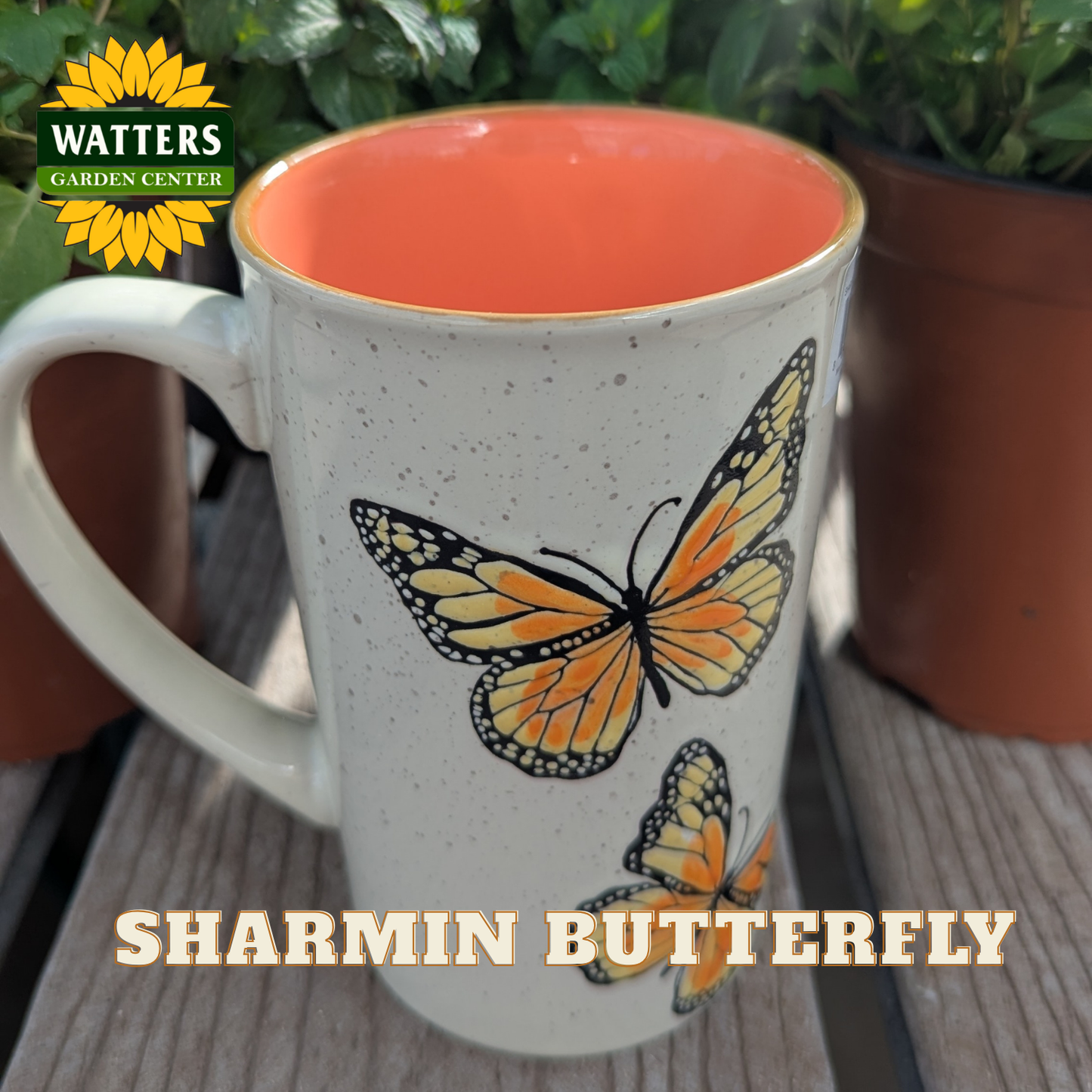 White mug with orange interior, butterfly design, and 'Watters Garden Center' logo.
