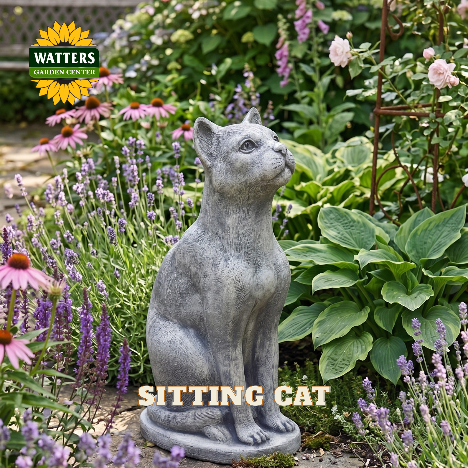 A gray stone-look statue of a sitting cat placed in a garden bed surrounded by purple flowers, green foliage, and plants. The Watters Garden Center logo appears in the top left, and the words 'SITTING CAT' are overlaid near the bottom.