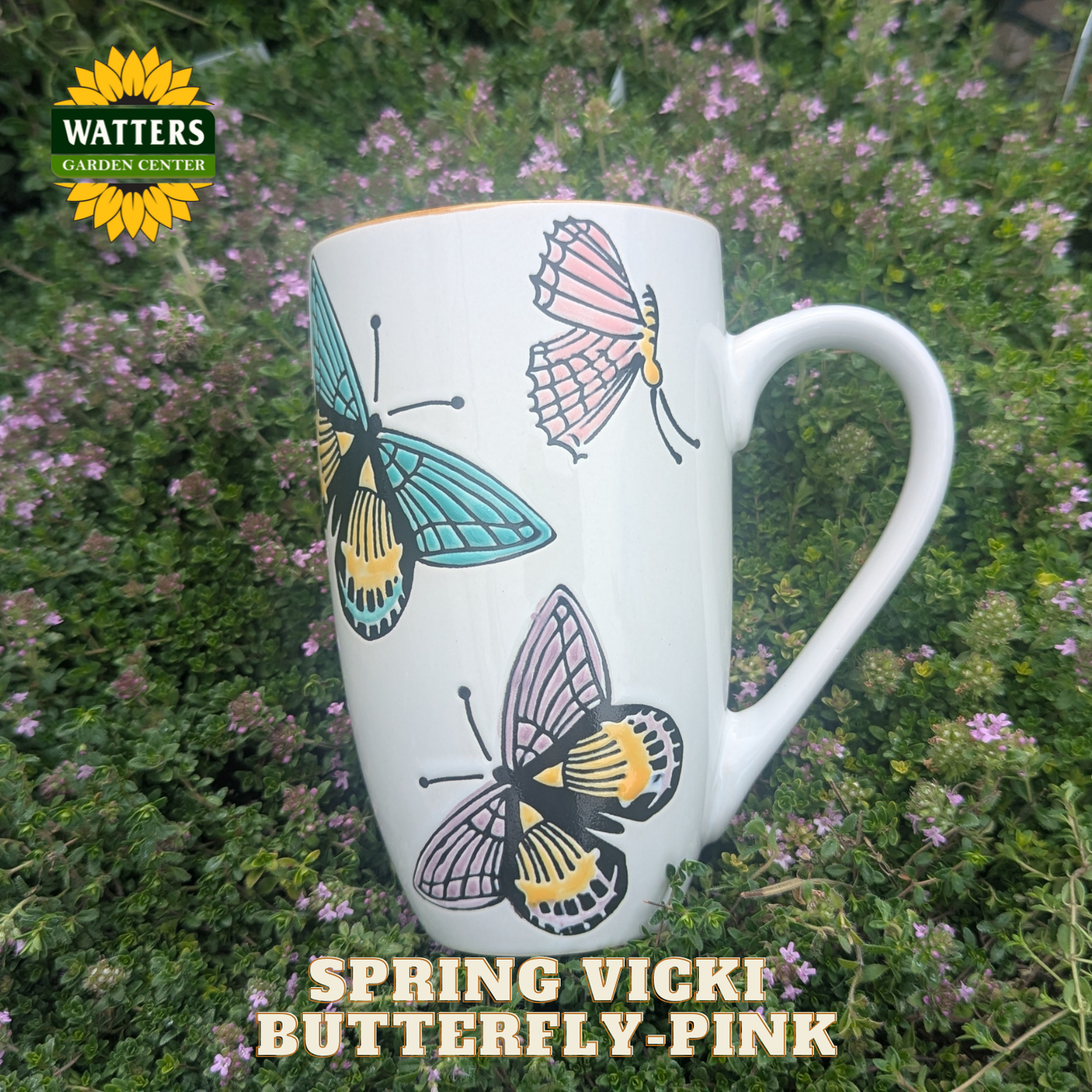 White mug with butterfly designs on a green background