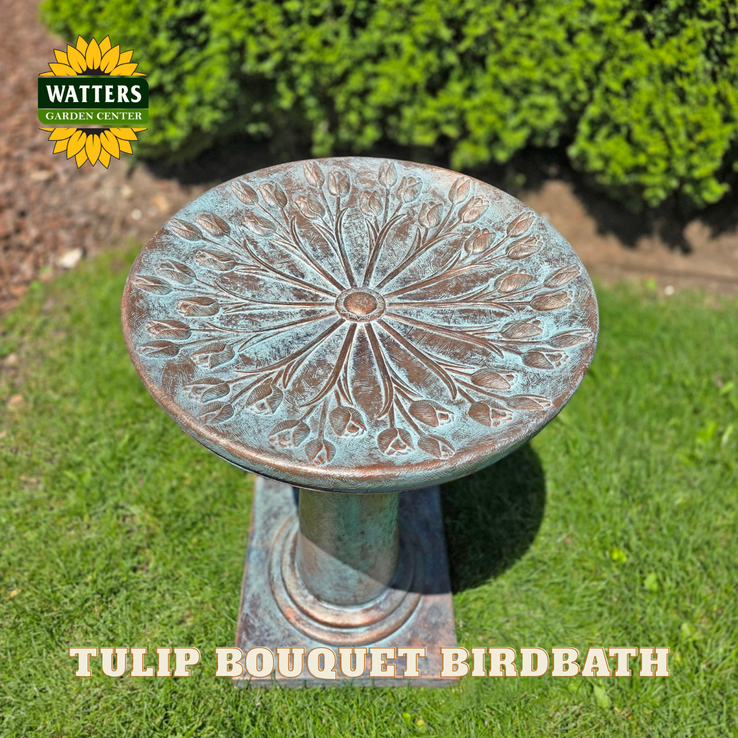 Decorative tulip bouquet birdbath on grass with Watters Garden Center branding.