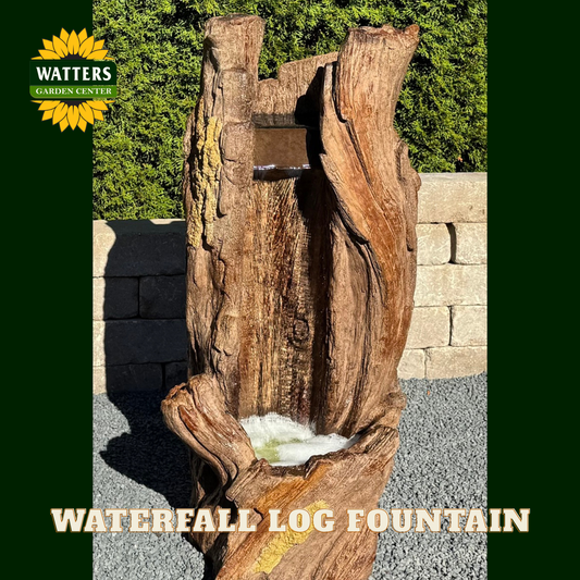Wooden waterfall log fountain with Watters Garden Center branding in a garden setting.