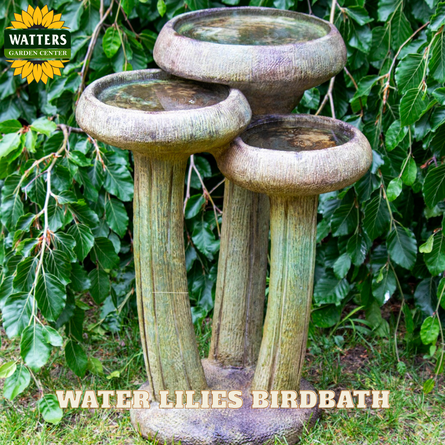 Three-tiered stone birdbath with 'Watters Garden Center' branding against a leafy background.