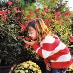Daughter smelling the roses